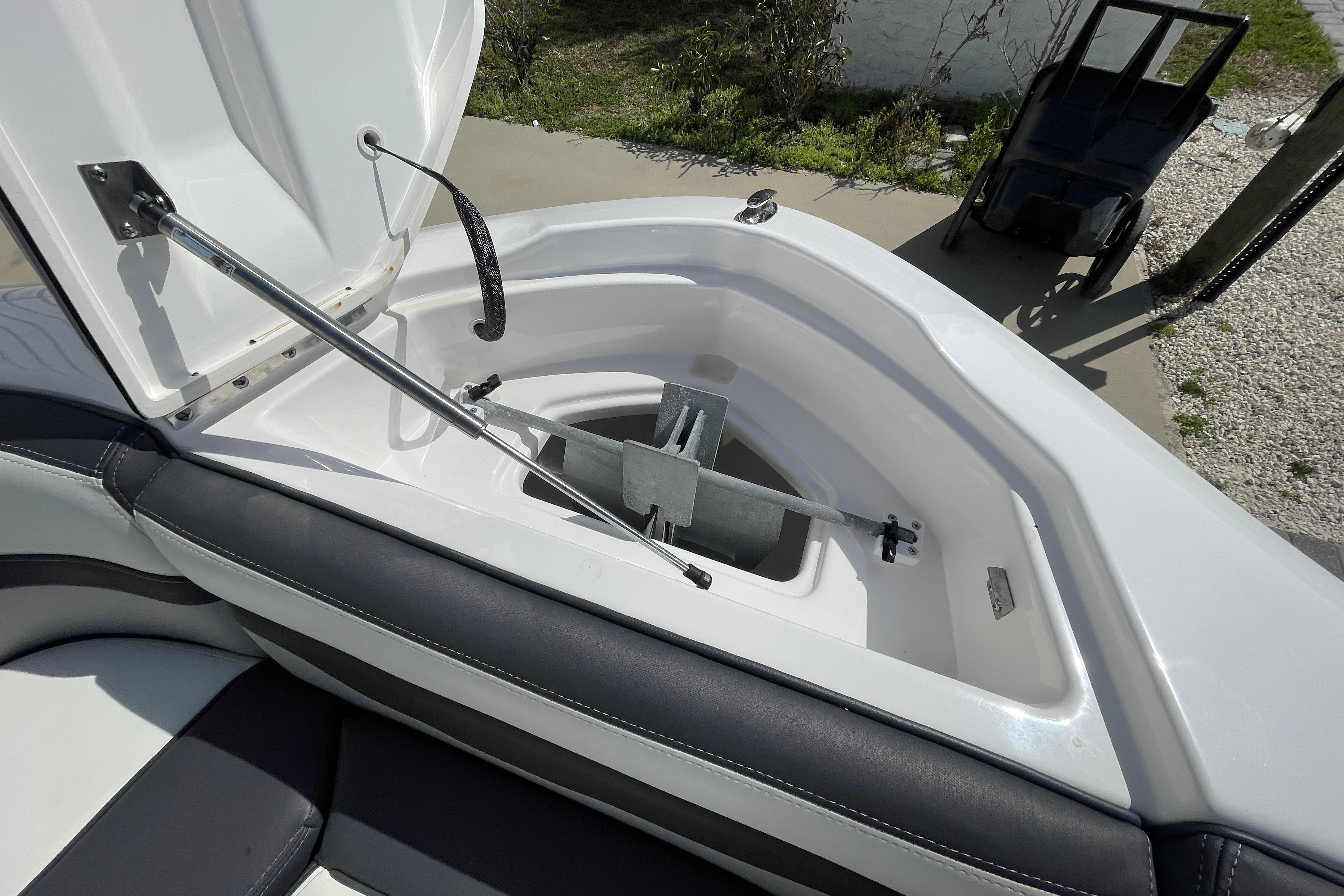 Open anchor compartment on 2021 Yamaha Boats 275SE, showcasing storage and mechanism.