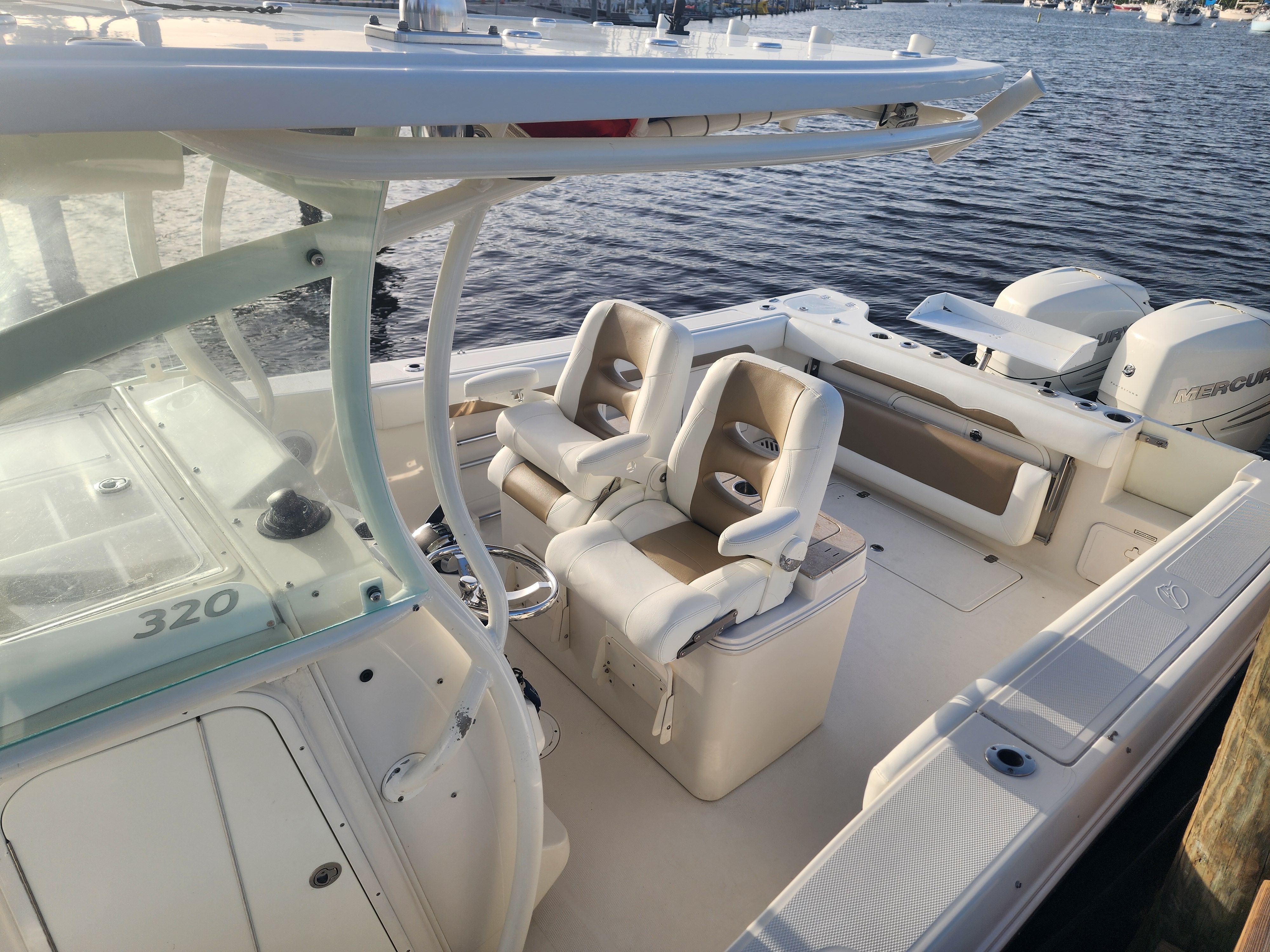 The image shows a 2017 Sailfish 320 CC boat with two seats and a helm station.