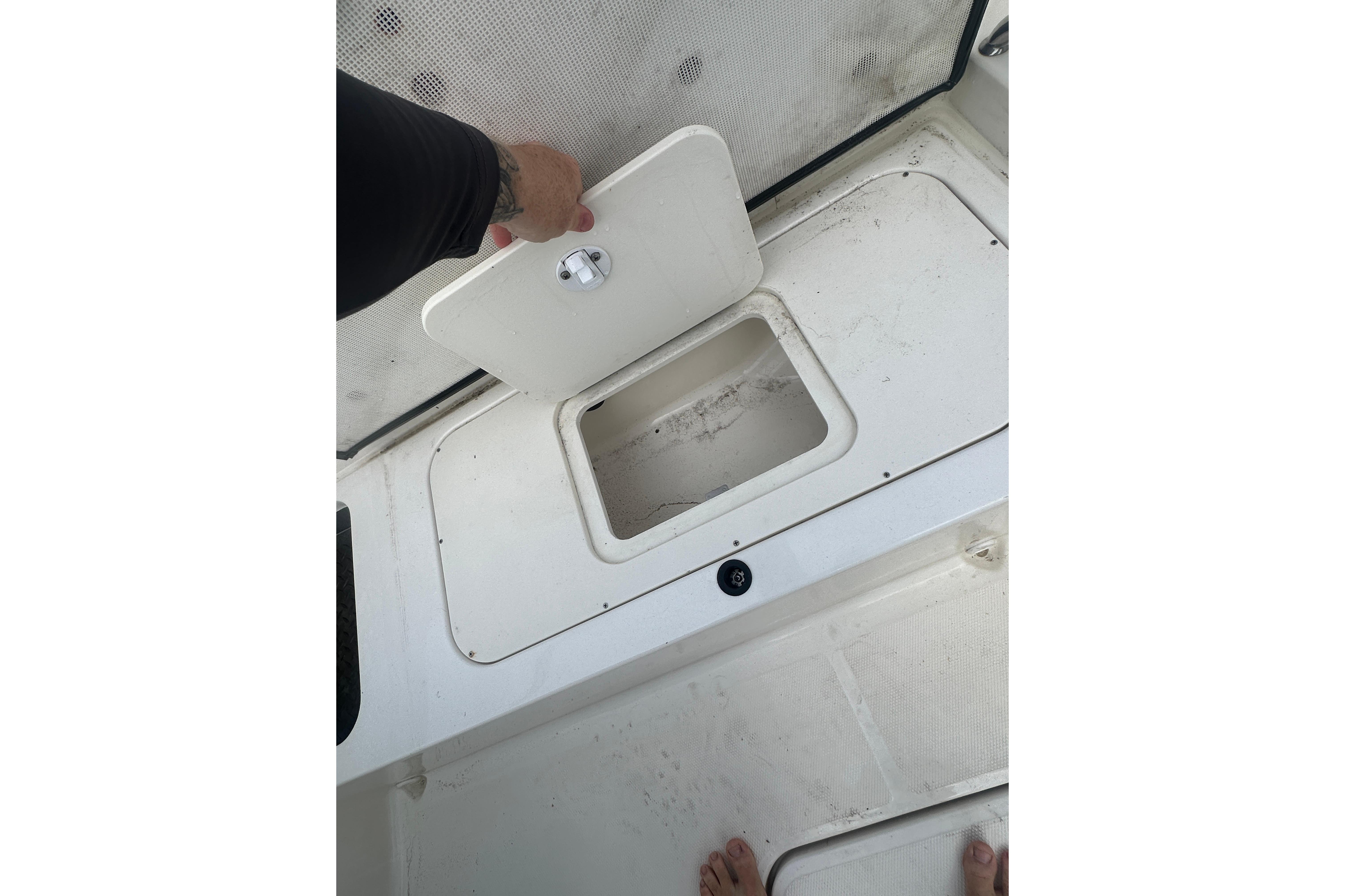 2017 Sea Ray SPX 190 Outboard boat storage compartment being opened.