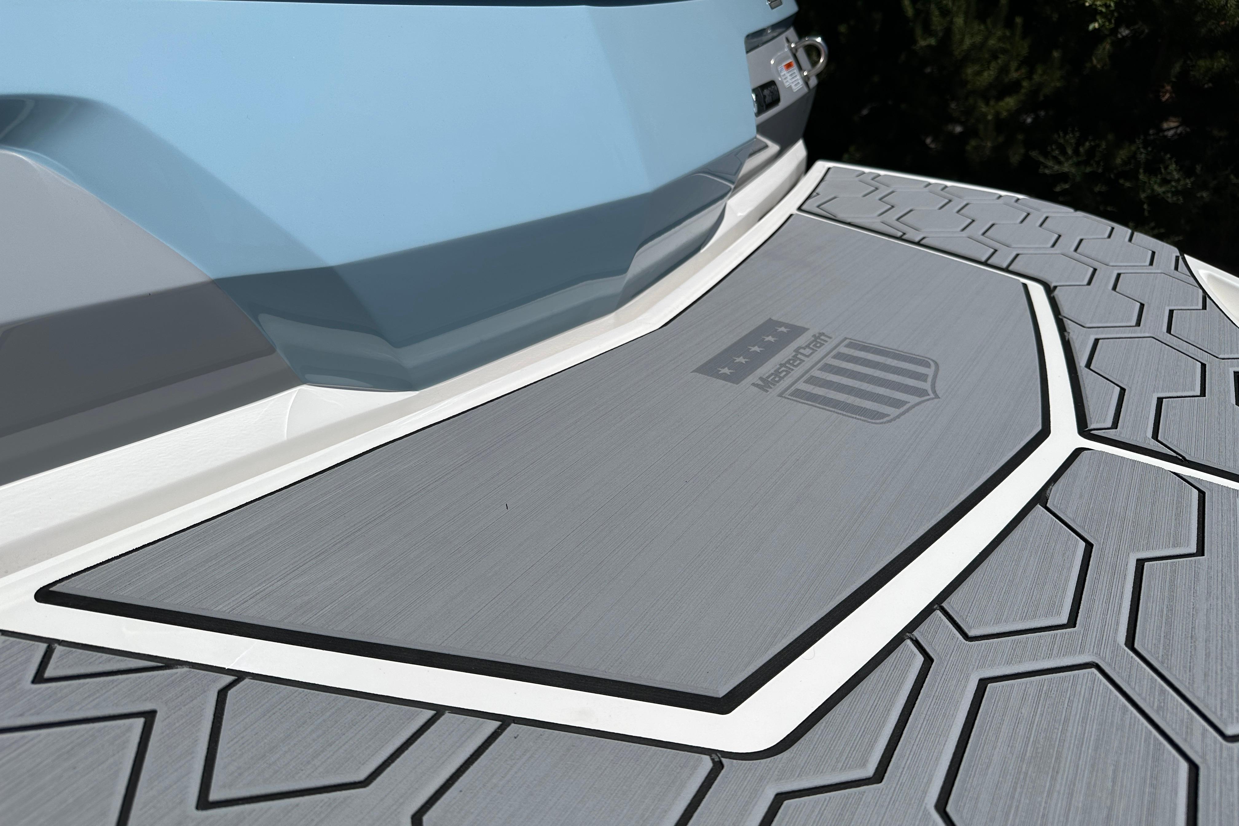 2023 MasterCraft NXT23 boat deck with textured surface and logo detail.