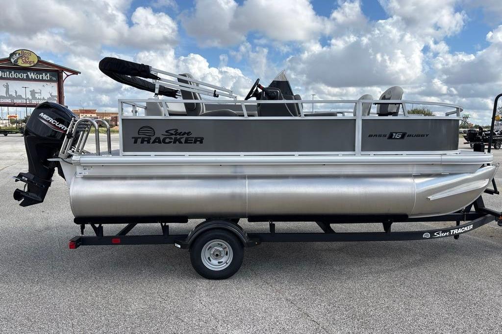 2026 Sun Tracker Bass Buggy 16 XL Select pontoon boat on trailer, outdoor setting.
