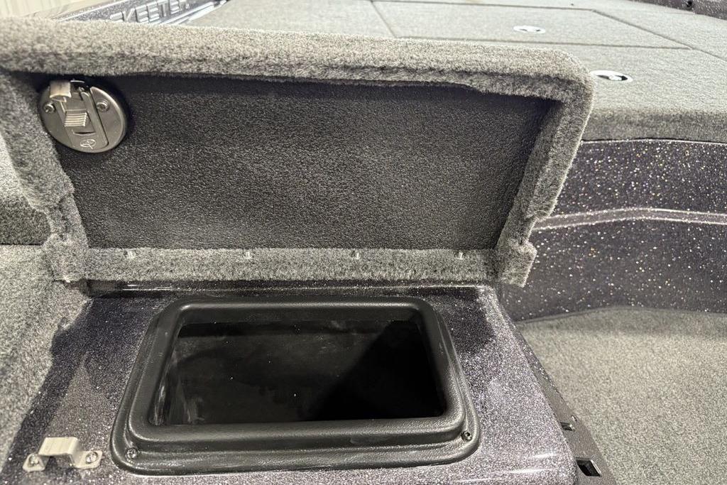 2025 Skeeter ZX150 boat storage compartment with open lid, showcasing interior space.