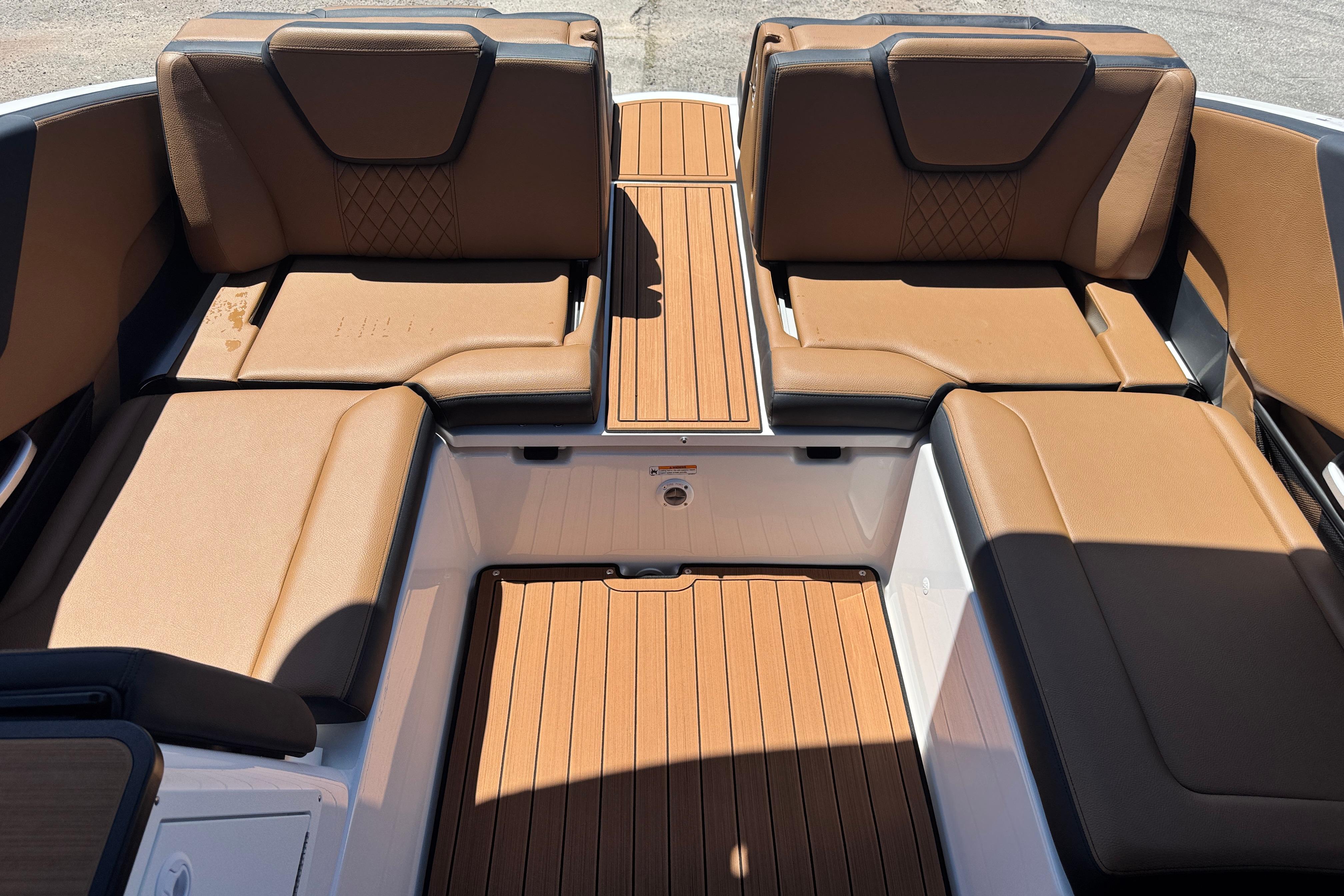 2026 Yamaha Boats 252SD interior with tan seating and wood-style flooring.