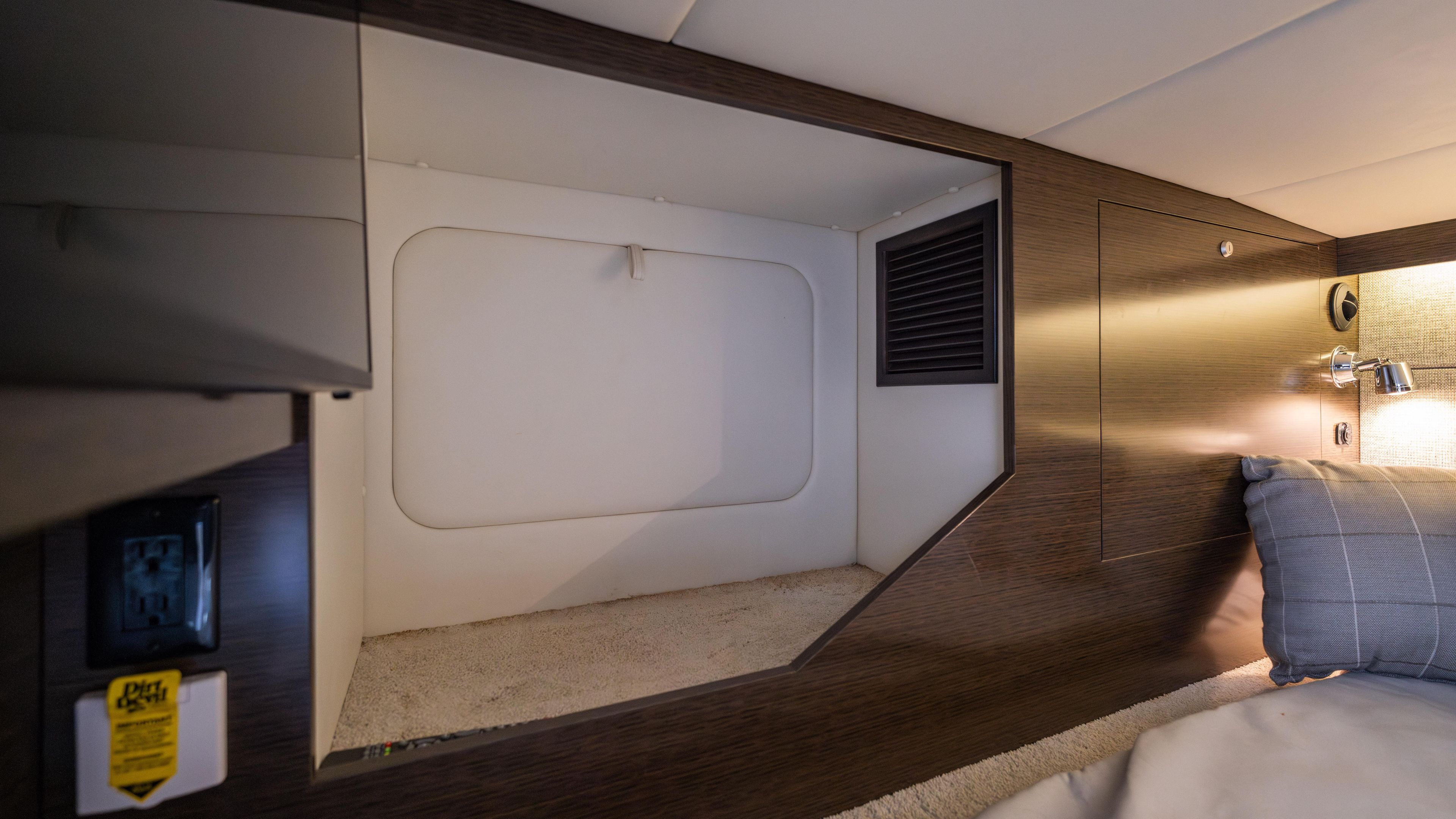 Interior cabin of 2020 Cruisers Yachts 38 GLS OB, featuring modern design and cozy bedding.