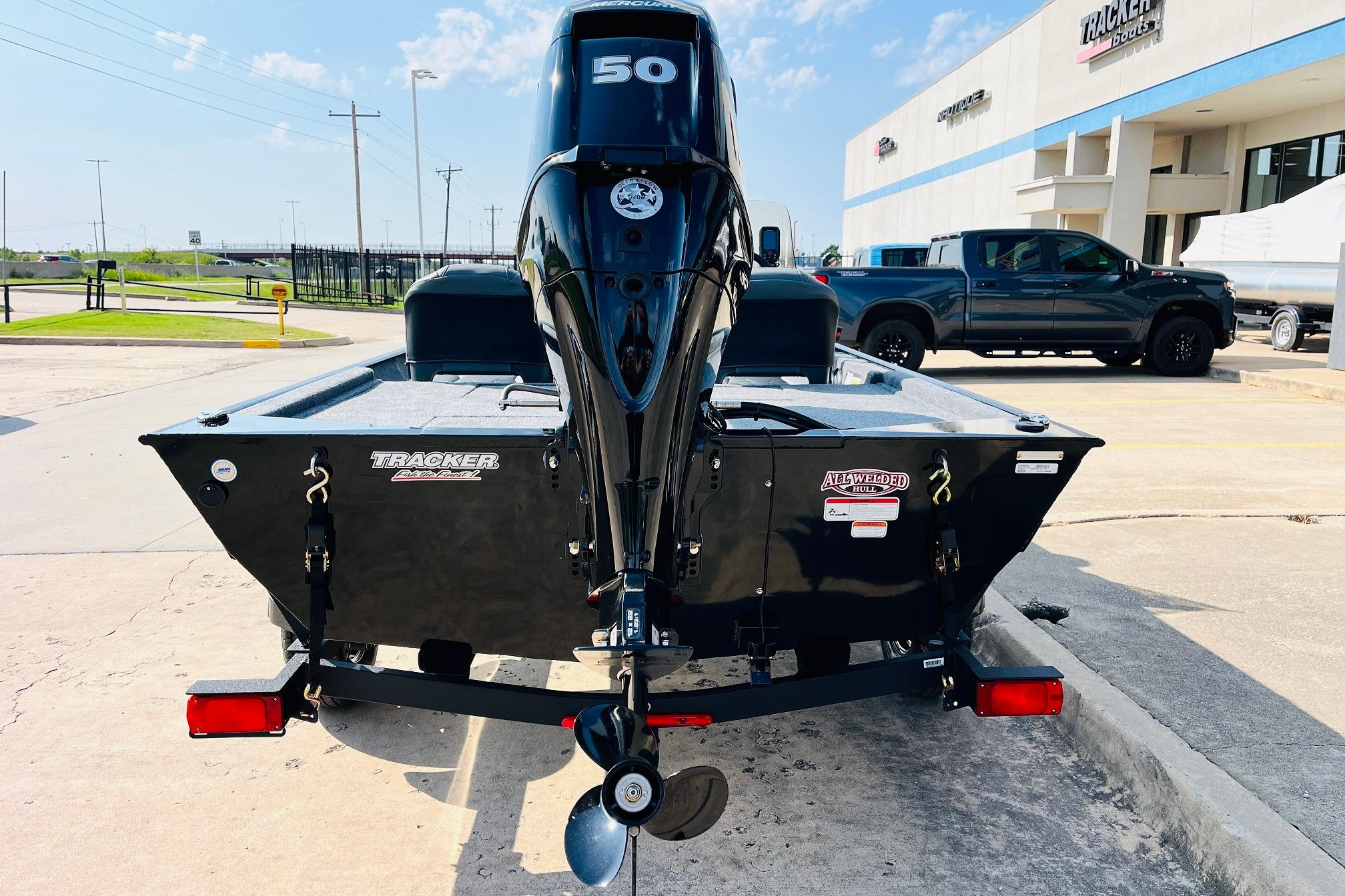 2026 Tracker Bass Tracker Classic XL boat with powerful outboard motor, parked outdoors.