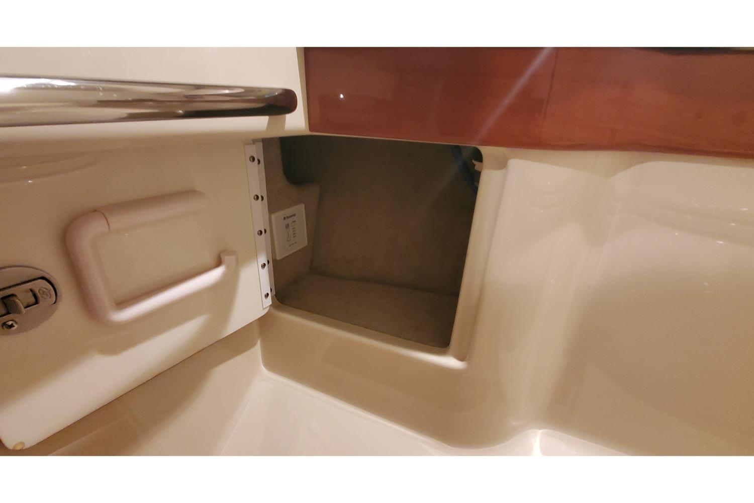 2012 Formula 310 Sun Sport interior storage compartment with handle and outlet.