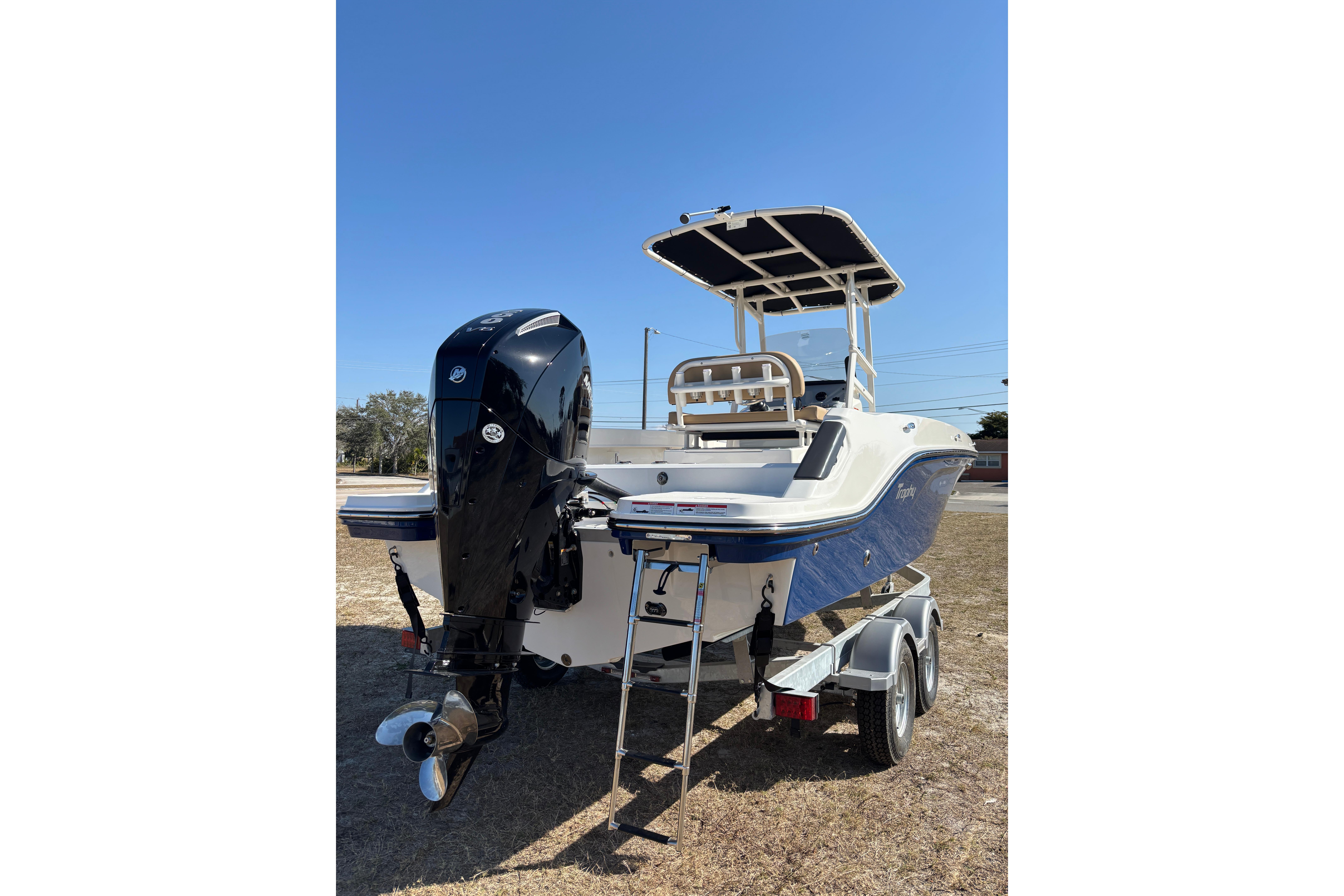 2026 Bayliner Trophy T22CC boat on trailer, rear view with outboard motor.