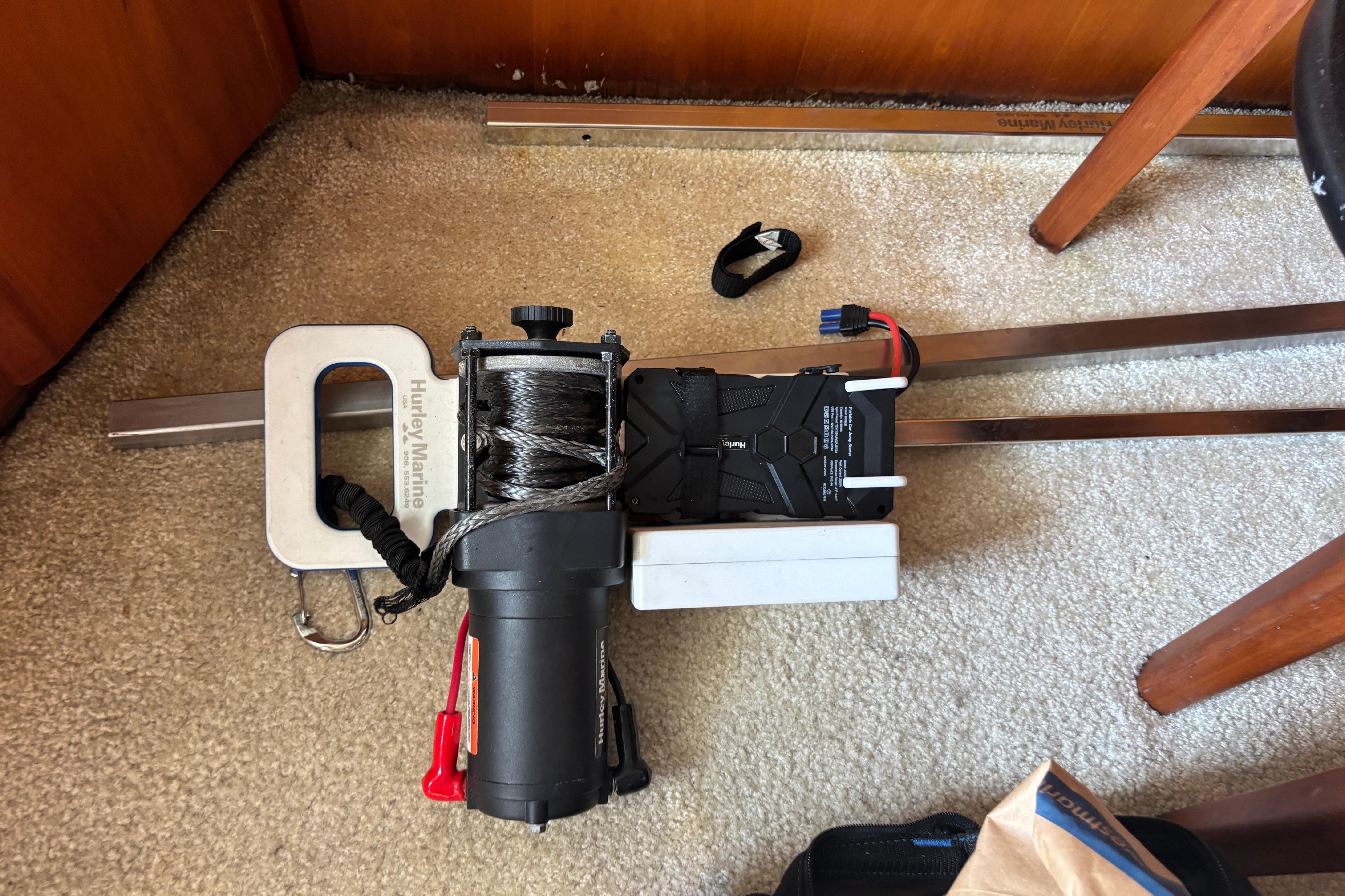 Electric winch on carpeted floor of 2001 Silverton 410 Sport Bridge boat.