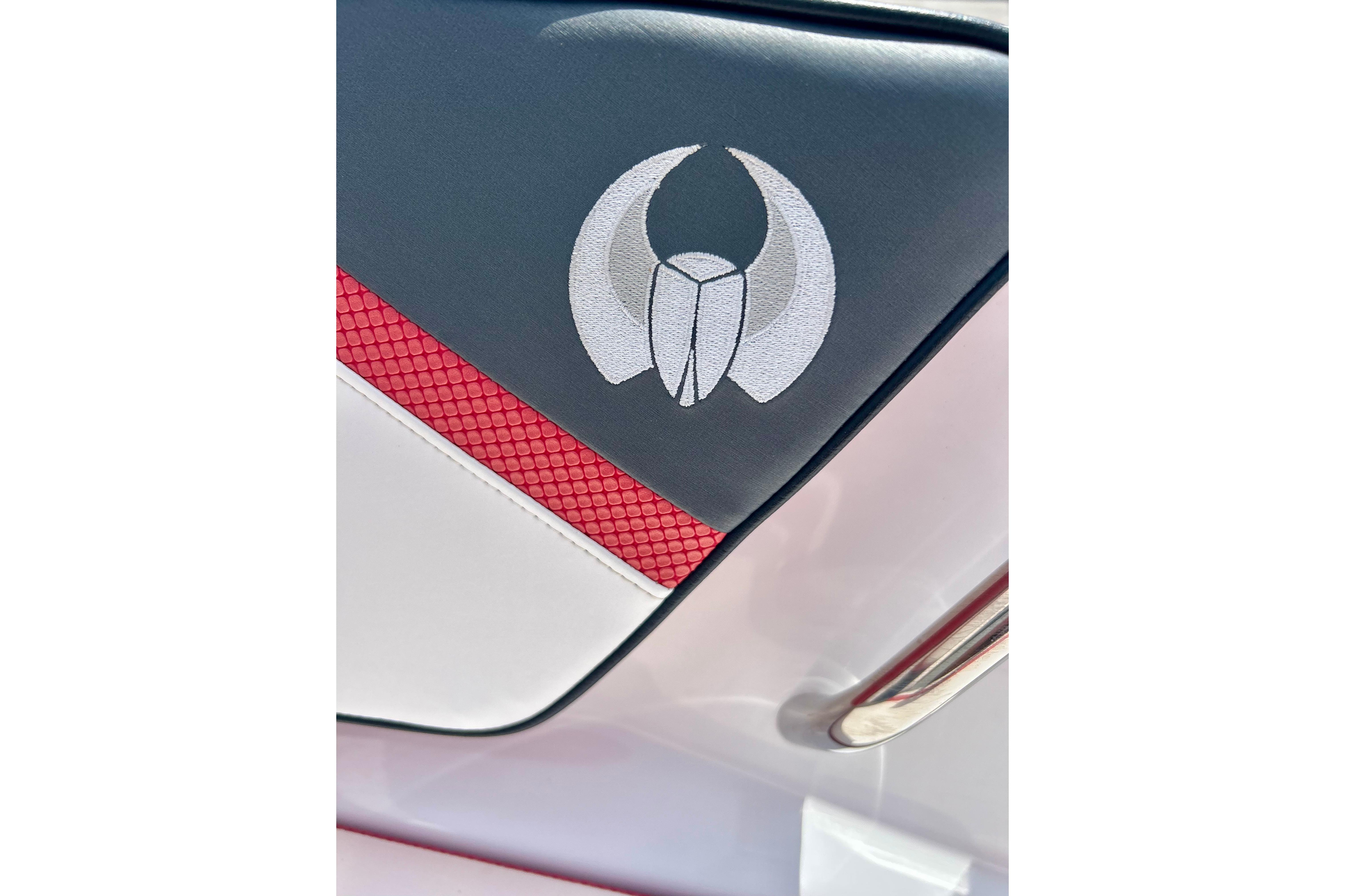 Close-up of 2021 Scarab 195 ID boat seat with logo and red accent.