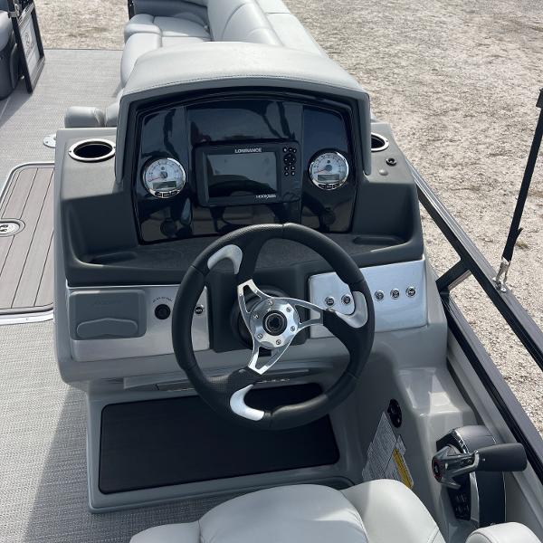 2023 Regency 250 DL3 boat dashboard with steering wheel and control panel.