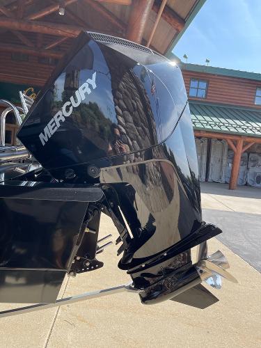 2024 Regency 230 DL3 with Mercury outboard motor in a sunny outdoor setting.
