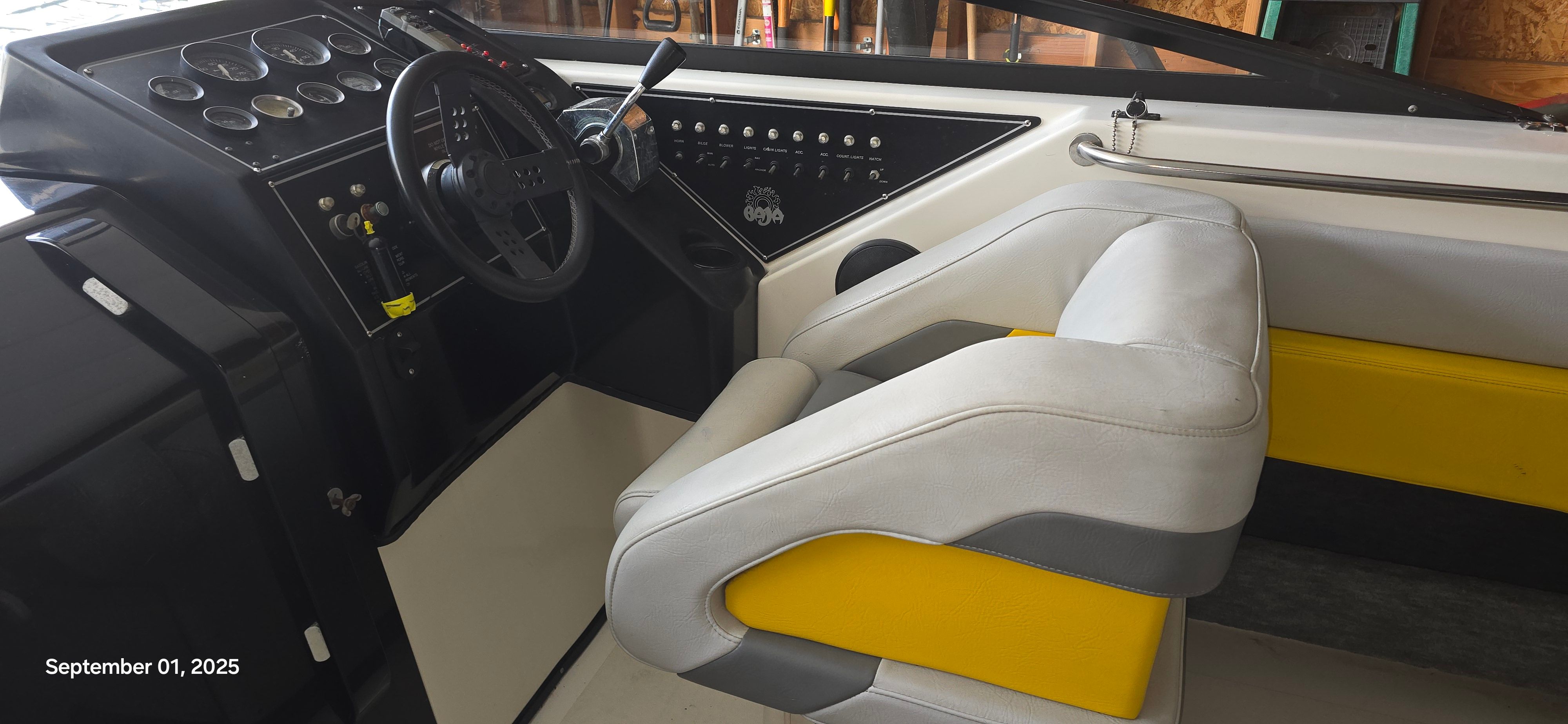 Interior of a 1989 Baja FORCE 235 with yellow and gray seating.