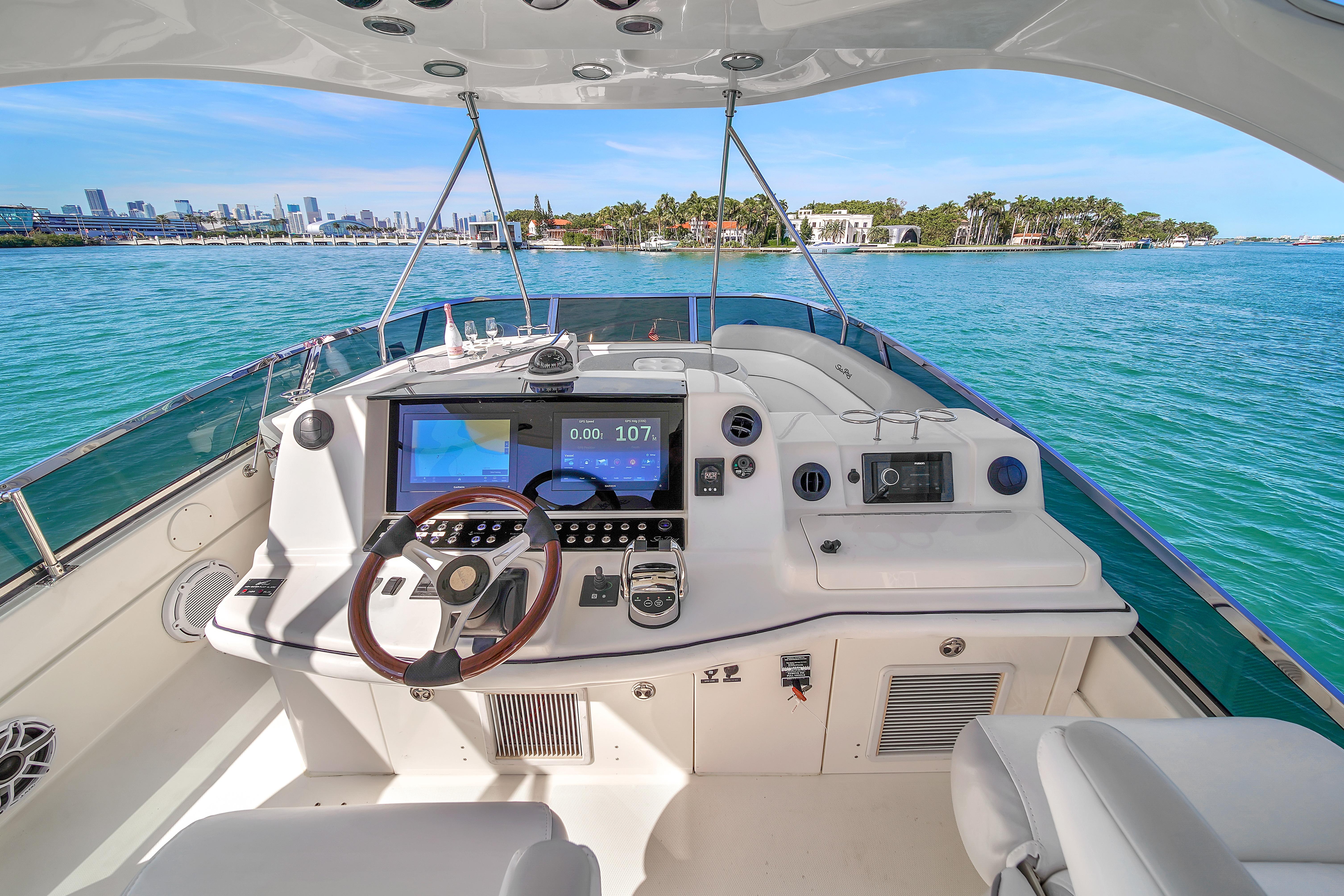 2007 Sea Ray 52 Sedan Bridge yacht helm with ocean view and modern controls.