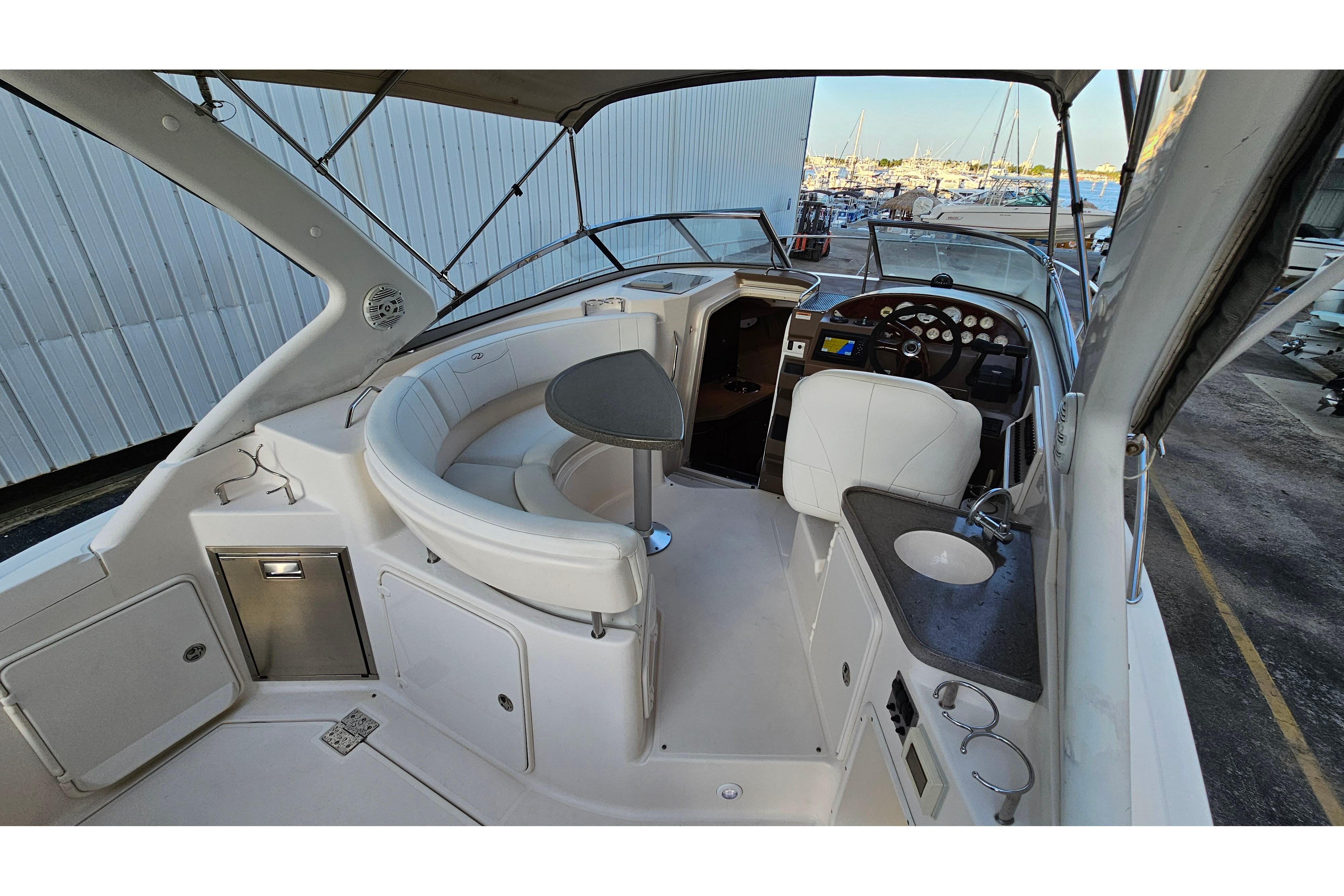 2005 Regal 3060 Window Express boat interior with seating, helm, and sink.