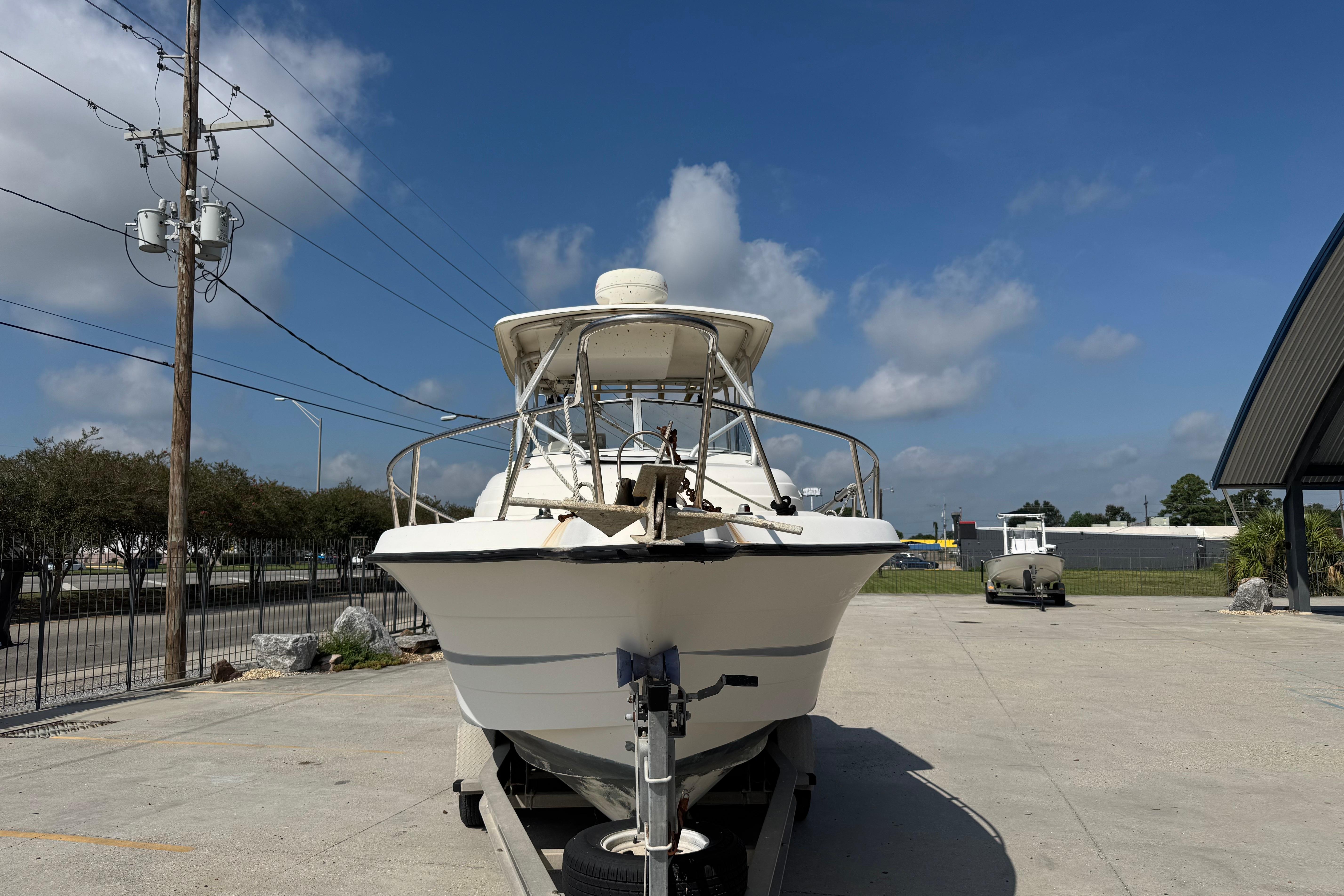 1997 Hydra-Sports VECTOR 2650 WA boat on trailer under clear blue sky.