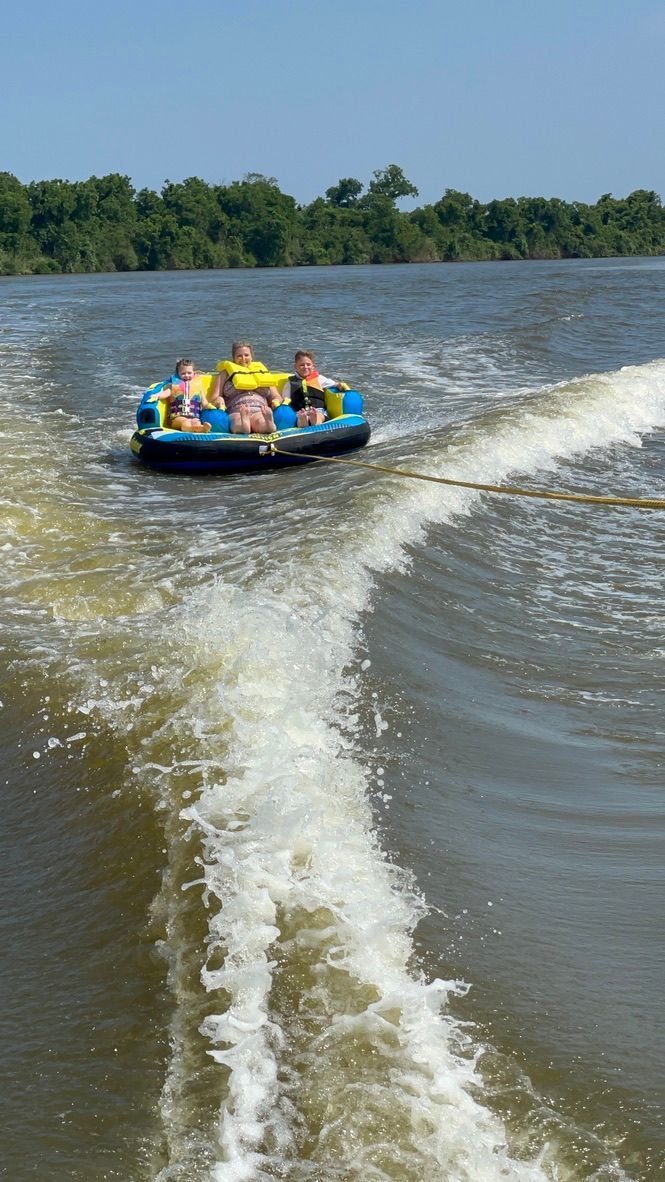 People tubing behind a 2021 Sea Pro Citation boat.