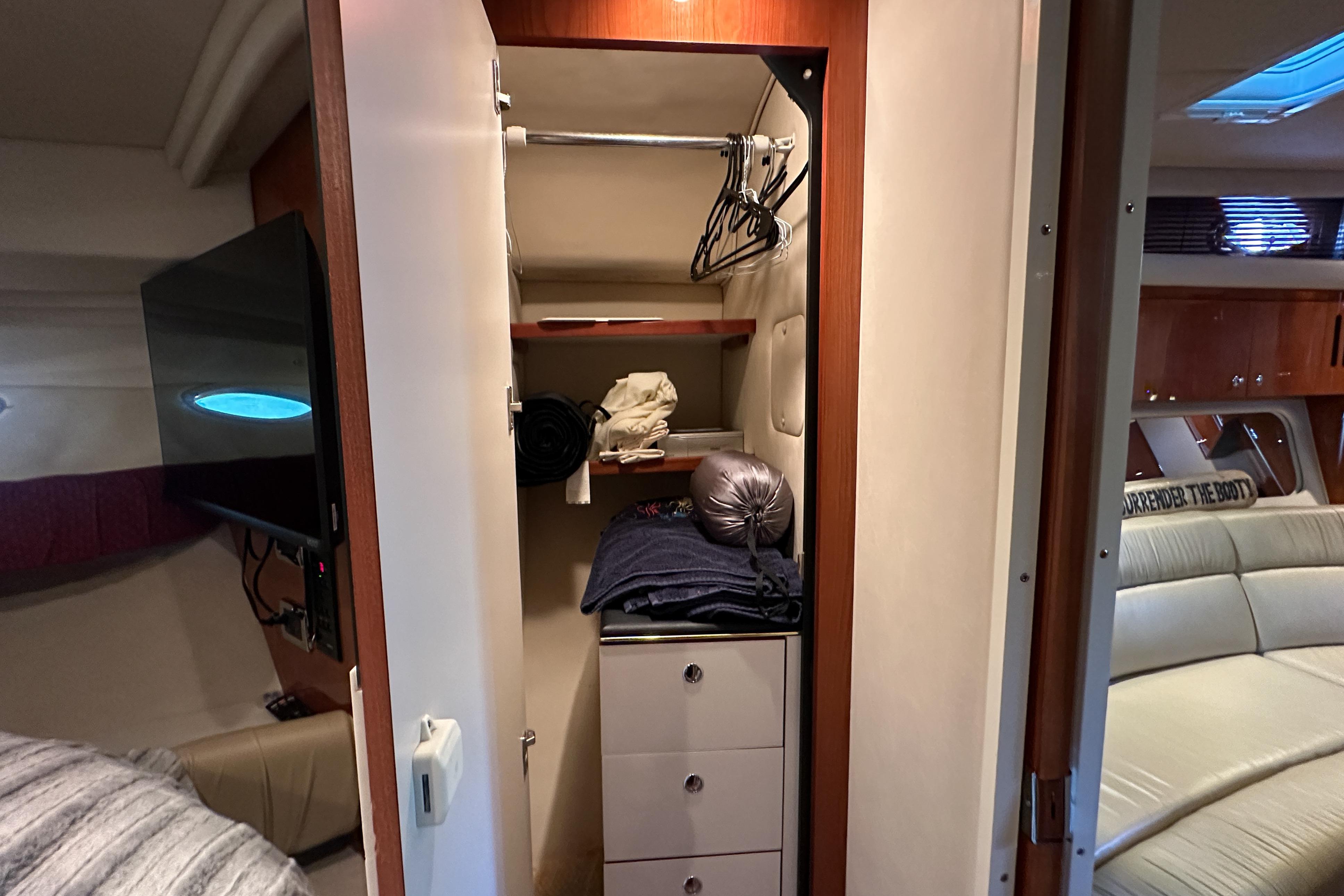 Interior of 2001 Sea Ray 410 Sundancer showing closet with hangers and storage.