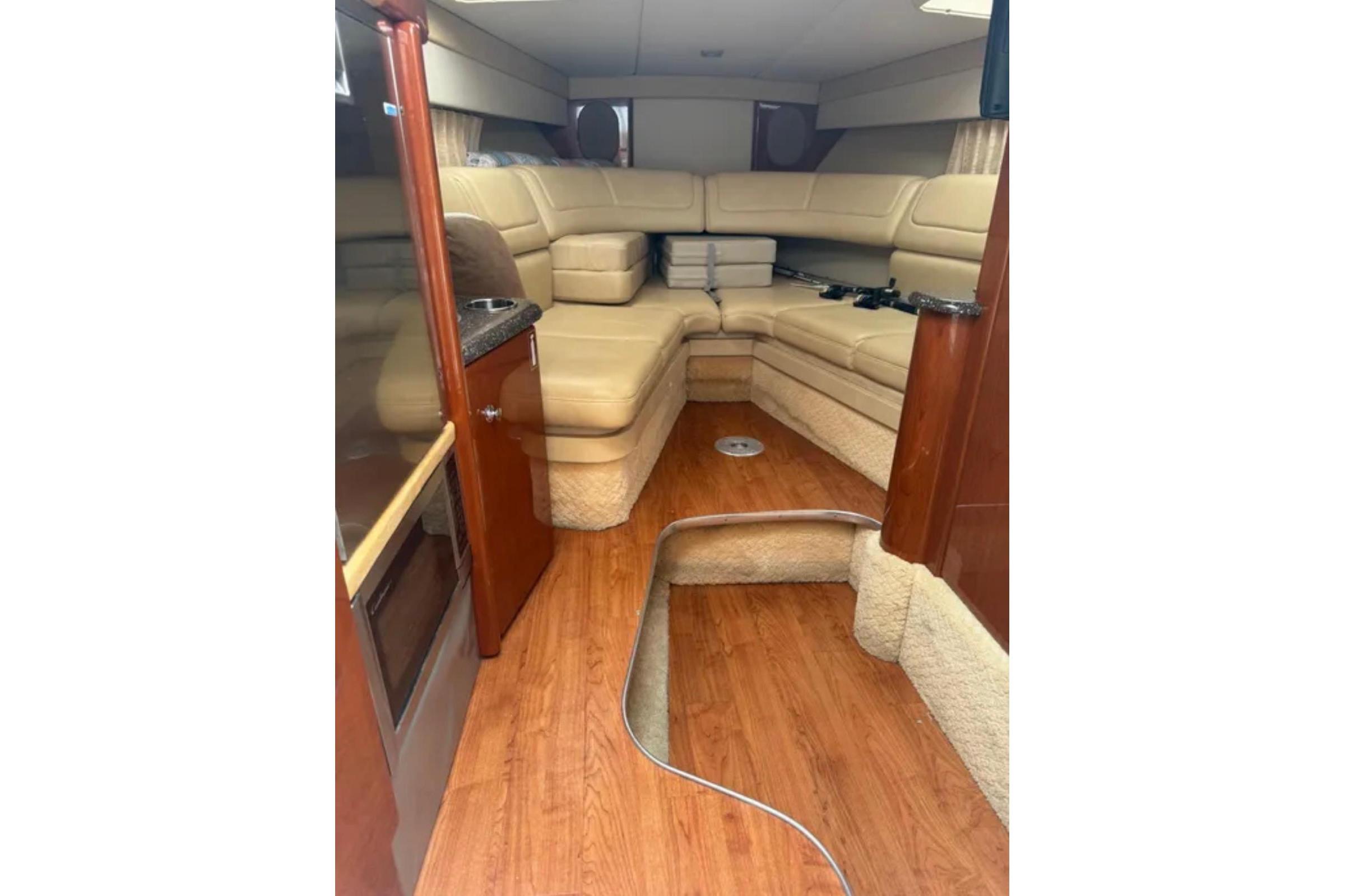 2010 Formula 310 Sun Sport cabin with beige seating and wood flooring.