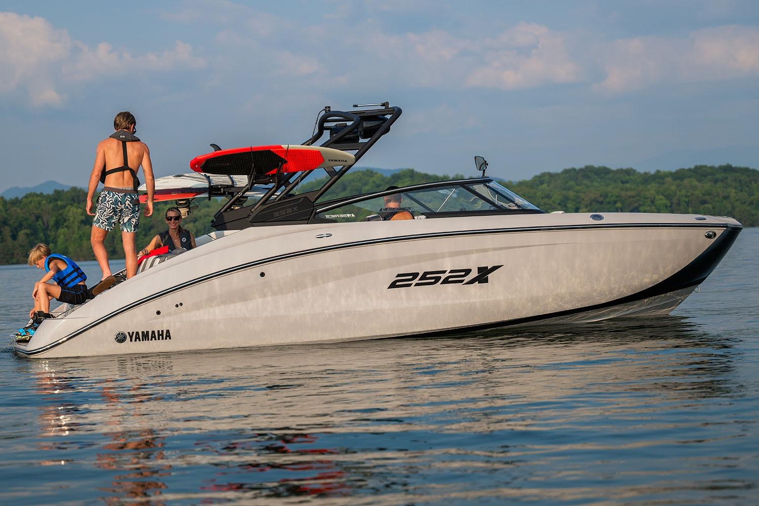 Manufacturer Provided Image: 2026 Yamaha Boats 252XE on a lake with people enjoying water activities.