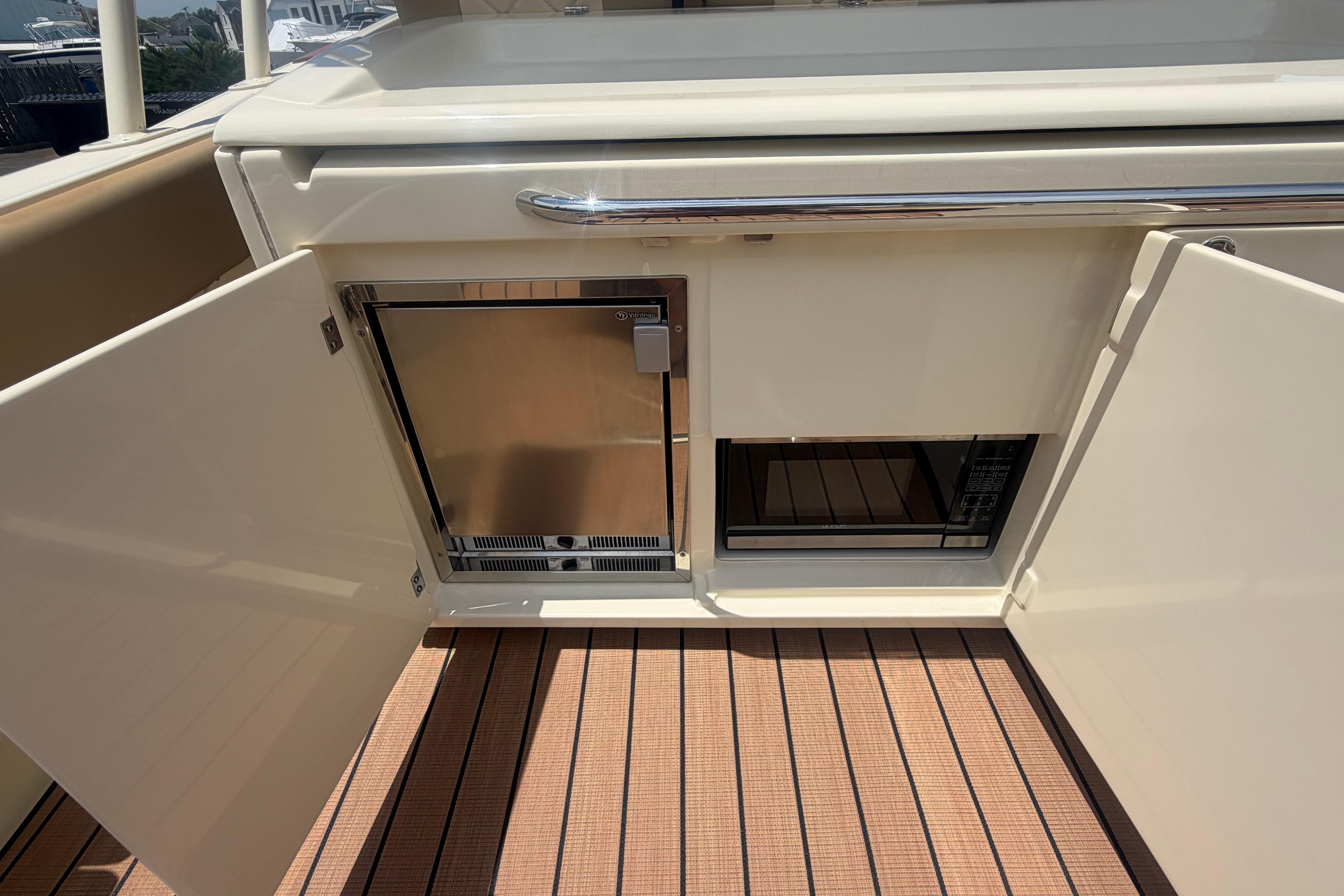 2017 Chris-Craft Catalina 34 boat interior with open storage compartments and appliances.
