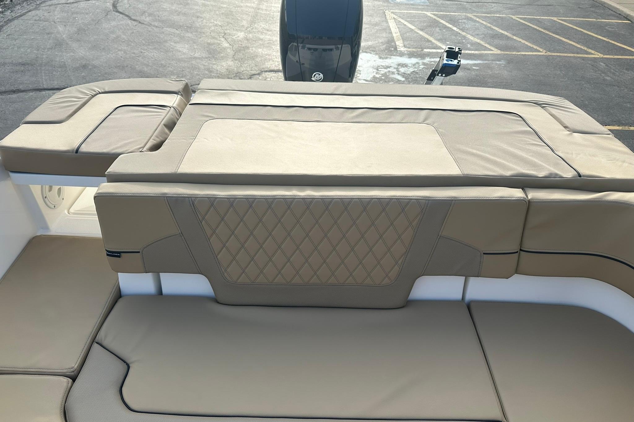 2026 Bayliner VR6 Bowrider OB with tan cushioned seating and diamond-patterned upholstery.