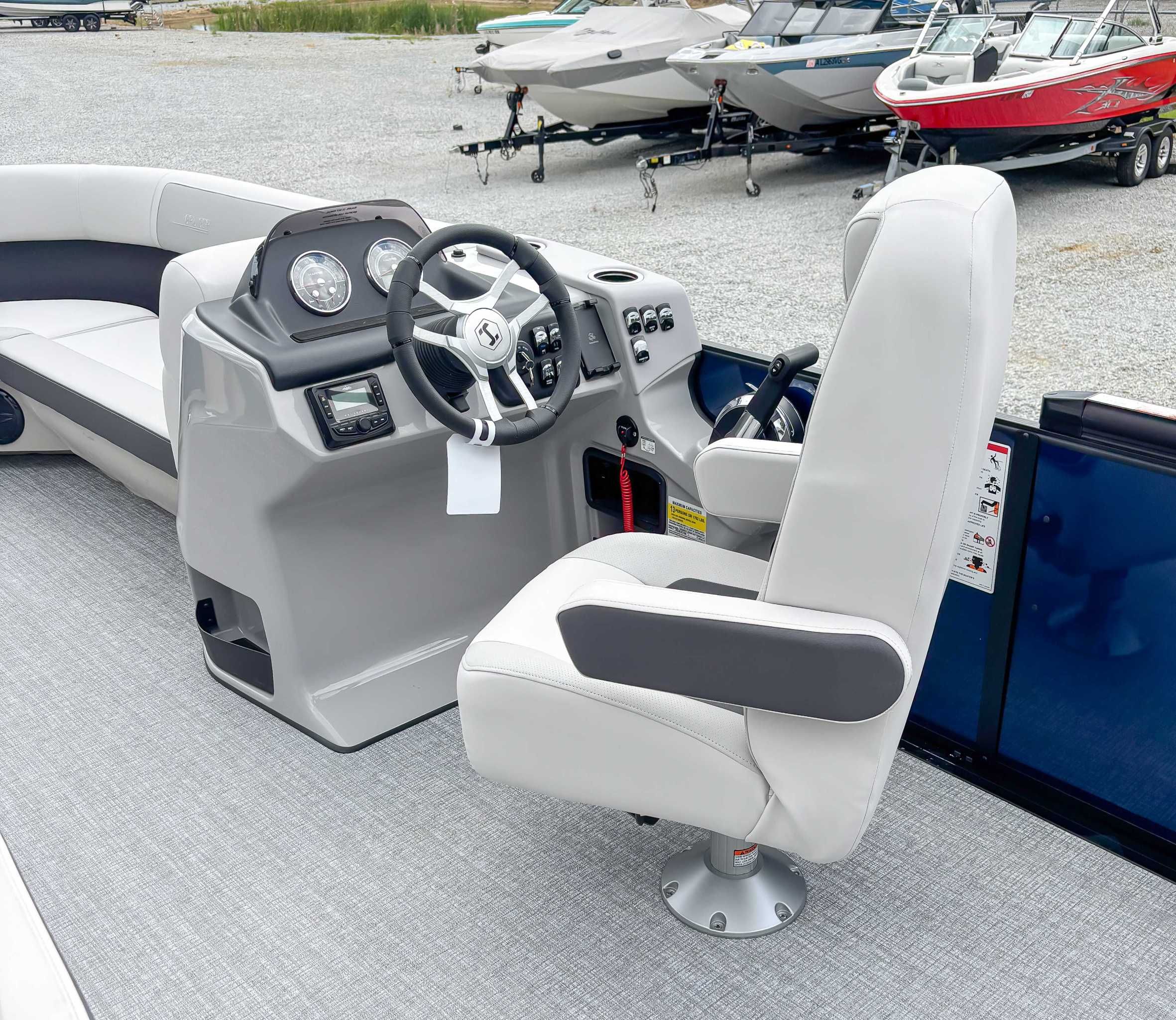 Interior of 2026 Harris Cruiser 230 SLDH with steering console.