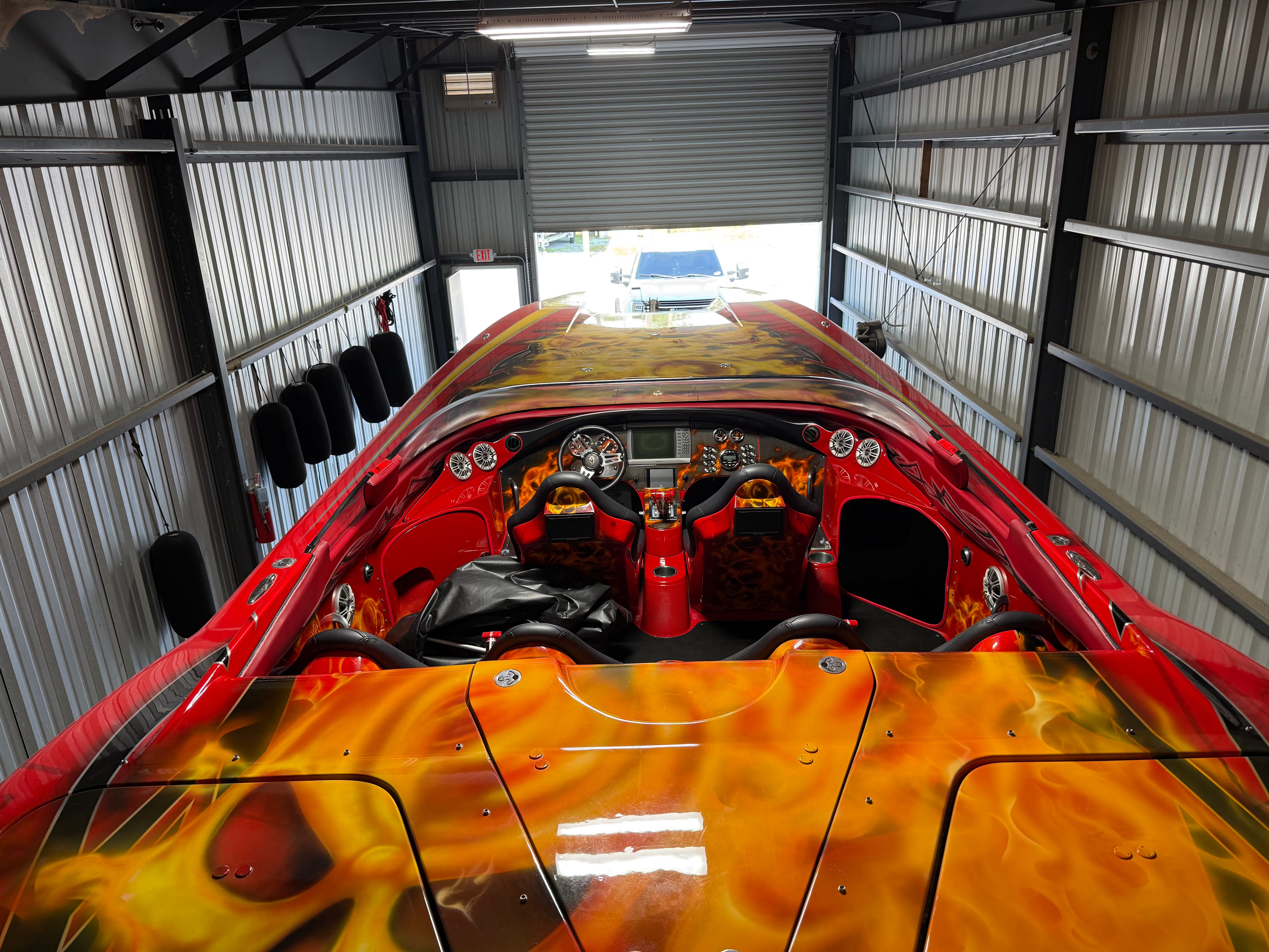 A 2010 MTI CAT with striking flame design inside a garage.