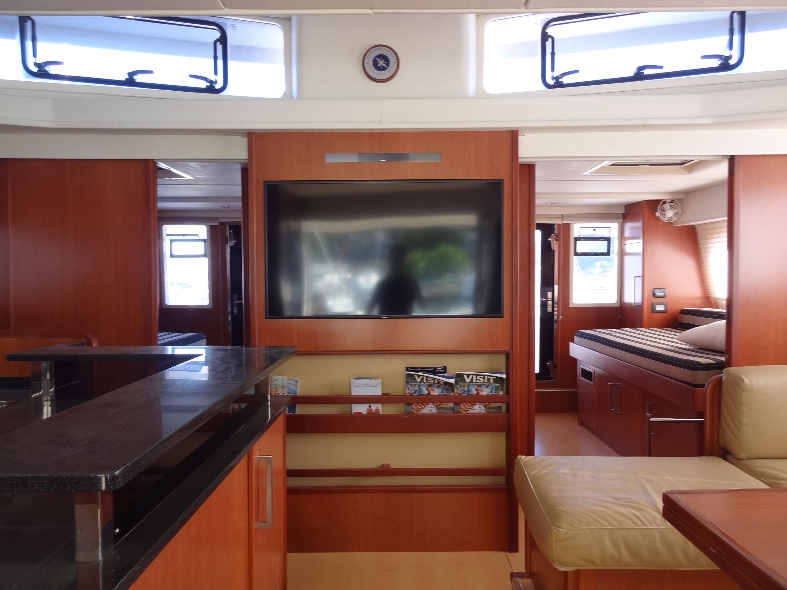 Luxurious interior of 2014 Leopard 58 yacht with TV and modern furnishings.