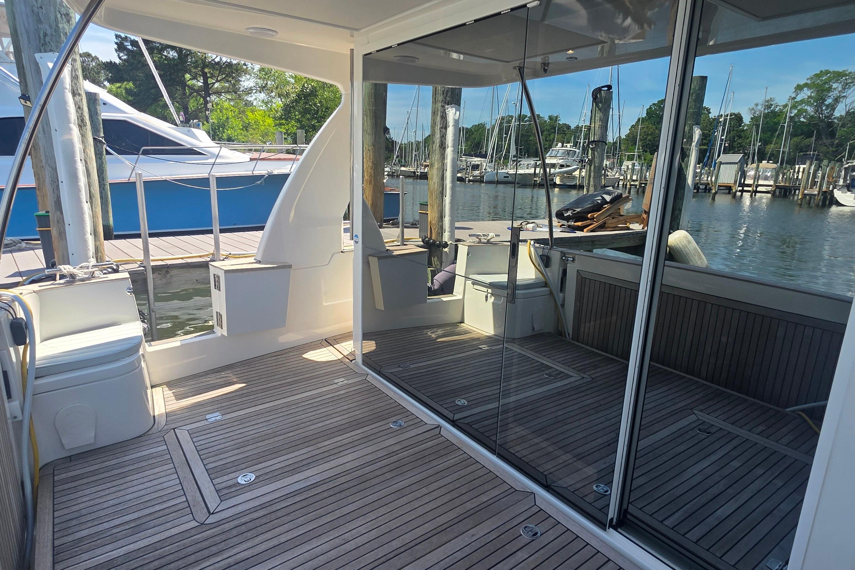 2023 Greenline 40 yacht deck with glass doors and marina view.