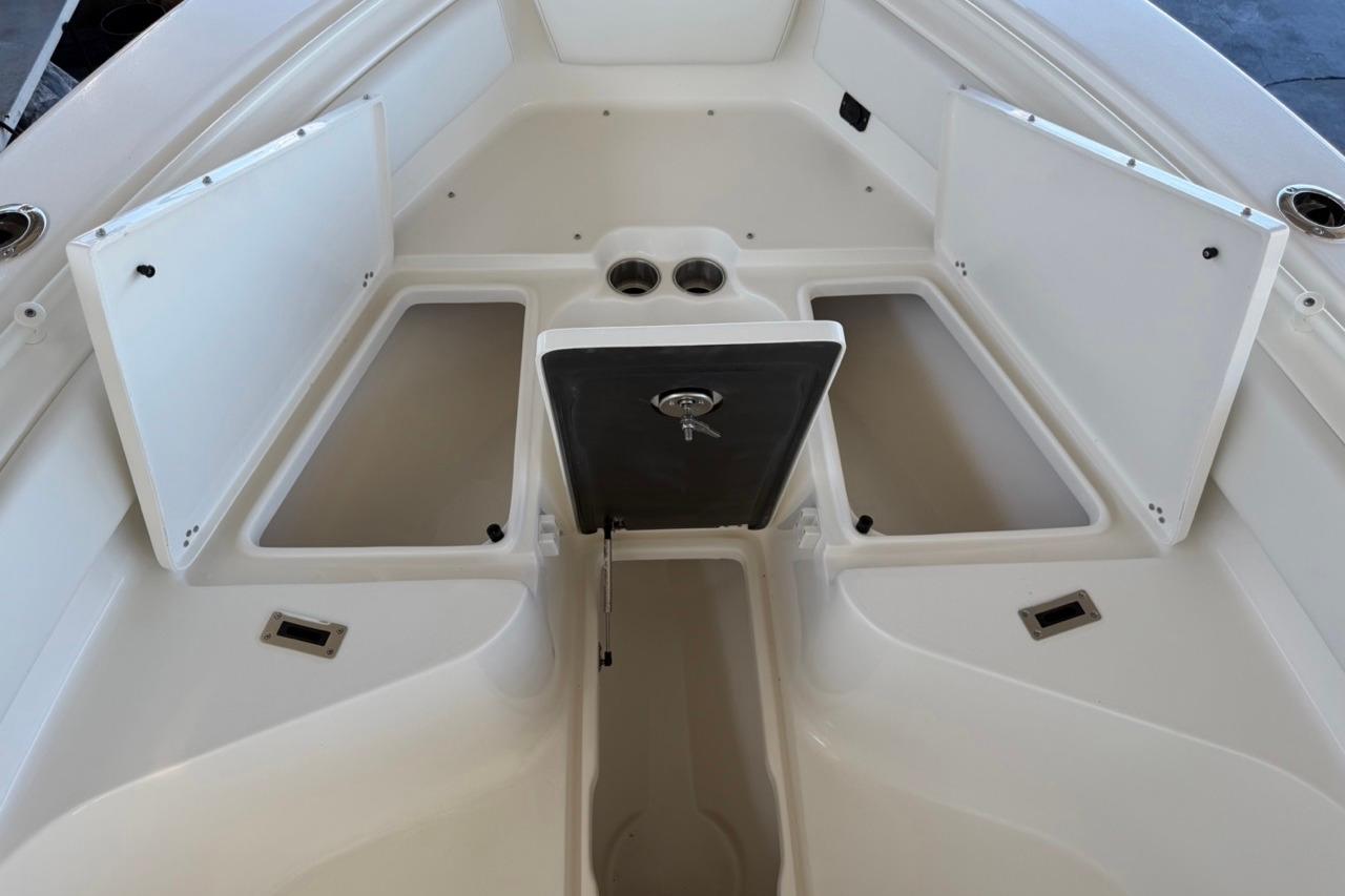 2026 Key West 239 FSR boat storage compartments open, showcasing spacious interior design.