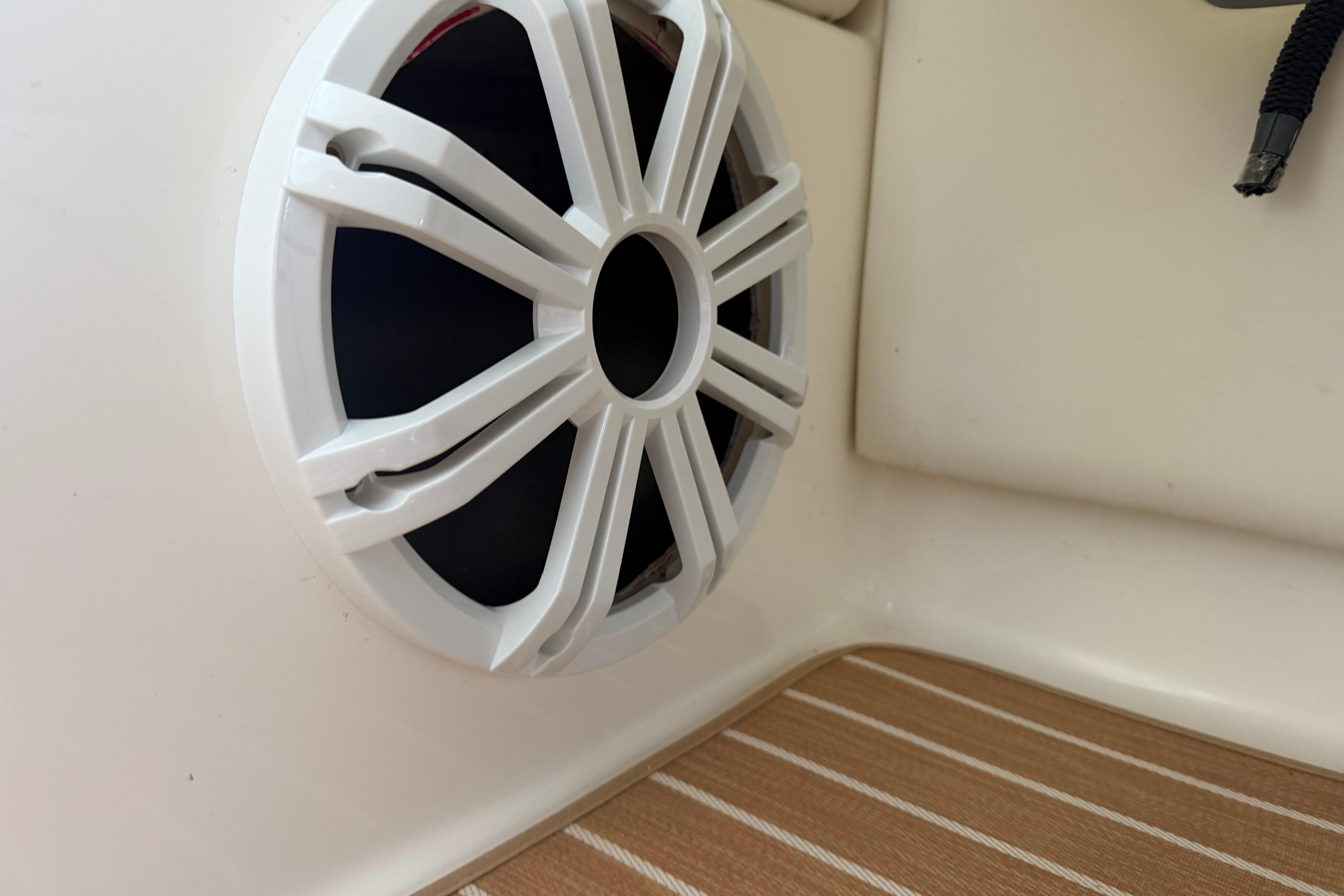 White speaker on a 2007 Sea Ray 270 SLX boat with wooden flooring.