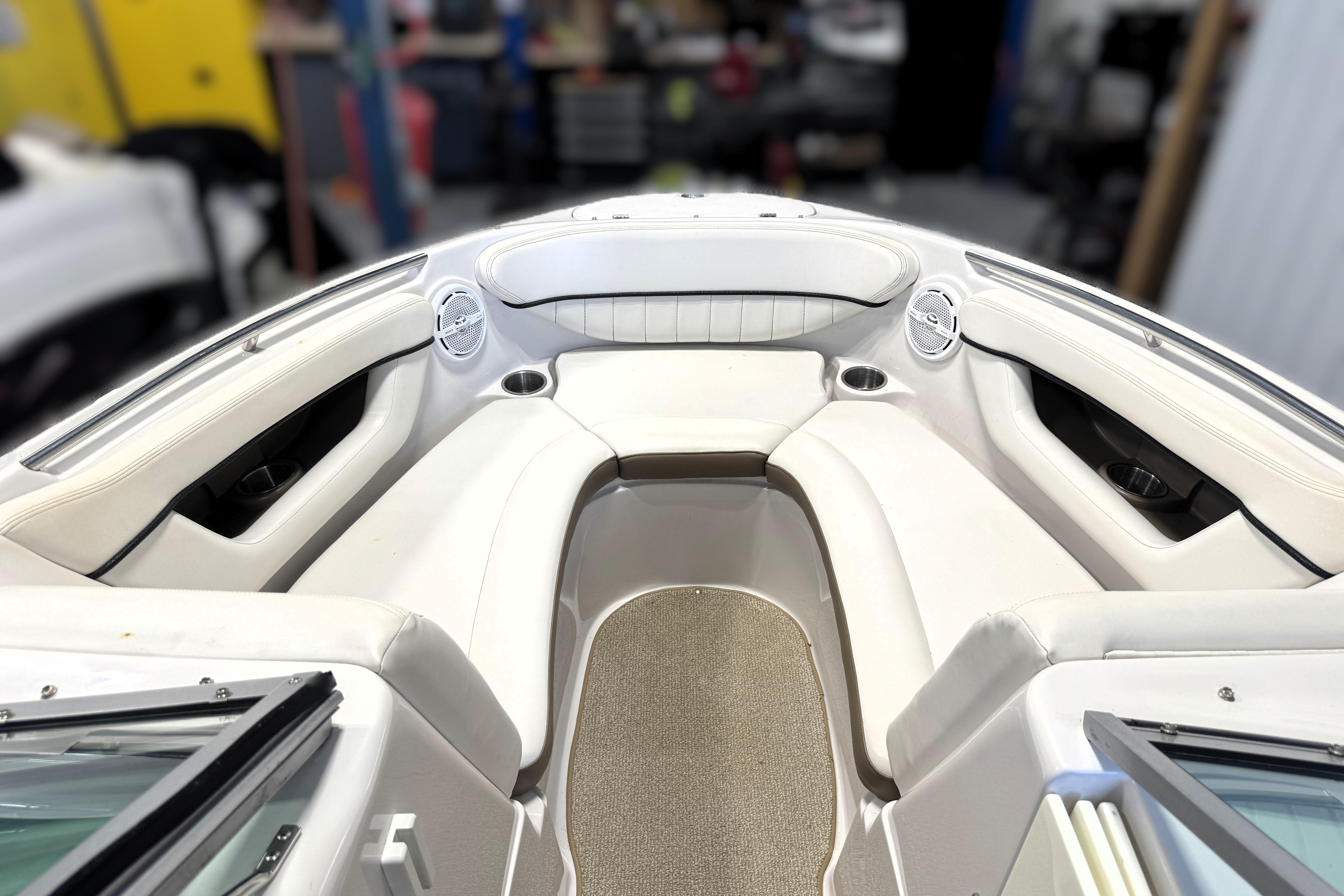 Interior view of a 2008 Four Winns H240 boat, featuring white seating and cup holders.