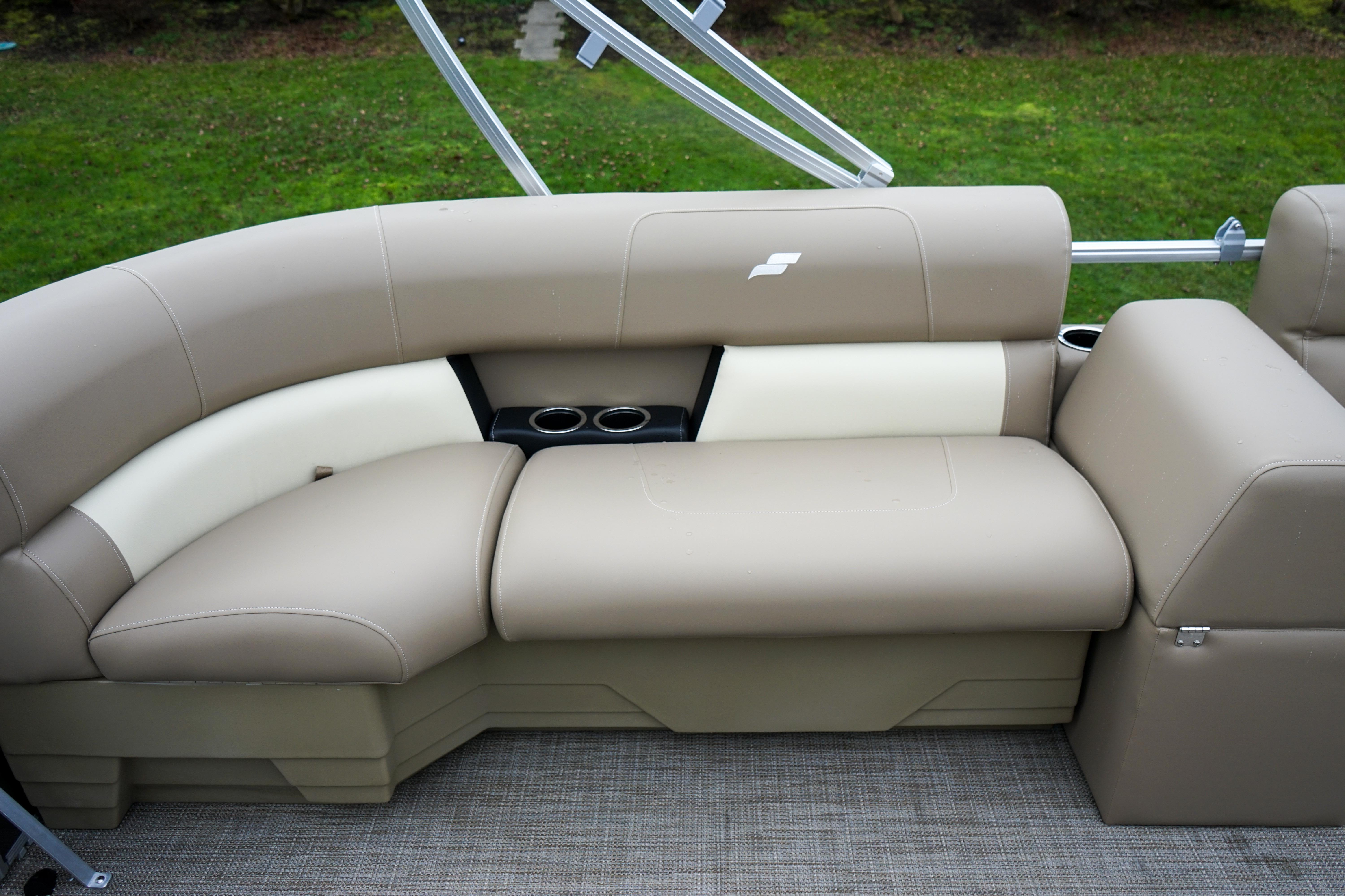 Luxurious beige seating on 2025 Starcraft LX16R boat, featuring cup holders and sleek design.