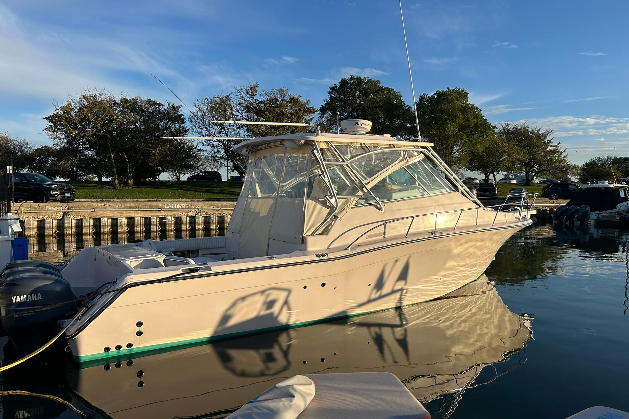 2007 Grady-White Express 360 boat docked on calm water, clear sky background.
