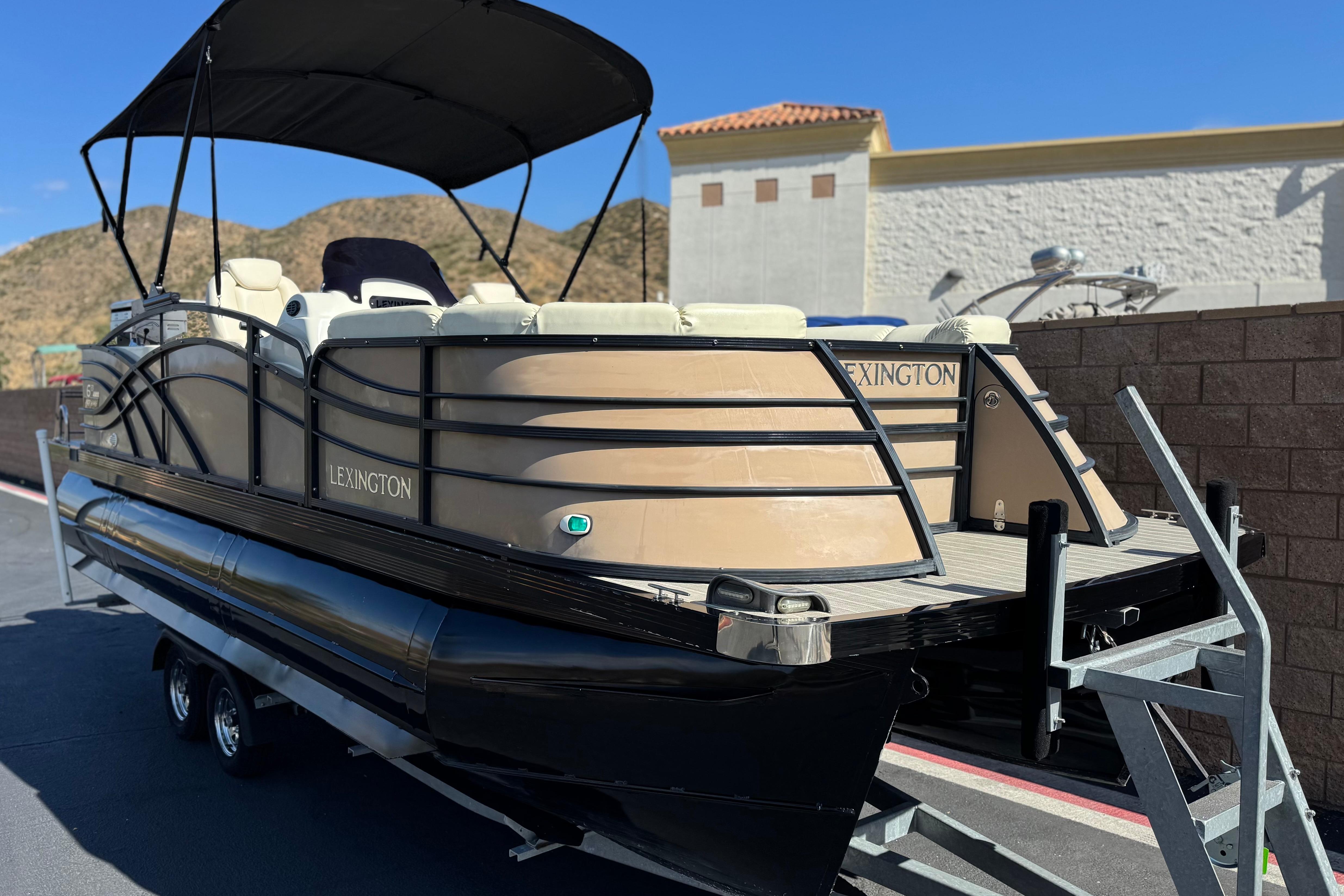 2023 Lexington 623 ST Xtreme pontoon boat on trailer, featuring sleek design and canopy.
