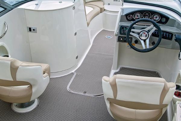 Manufacturer Provided Image: 2018 Stingray 214 LR boat interior with beige and white seating, steering wheel, and dashboard.