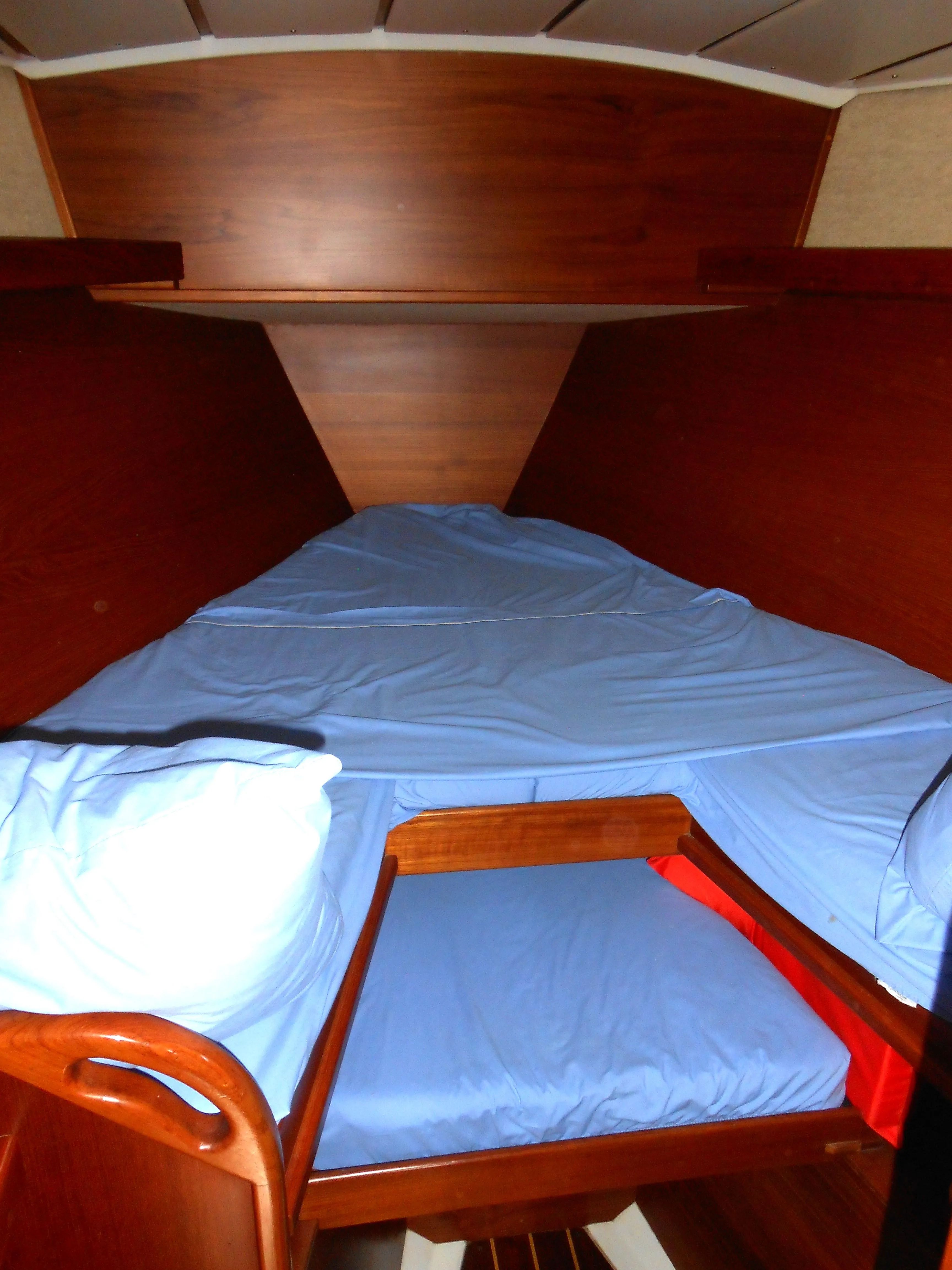 Interior of a 1985 Contest 41 Ketch with blue bedding.