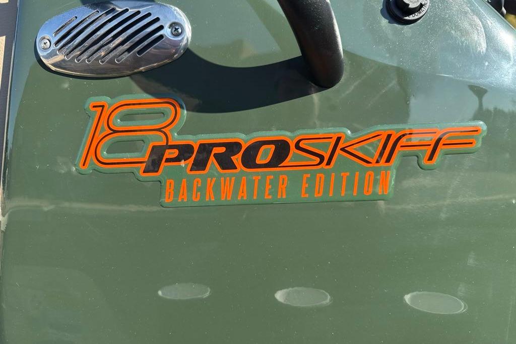 2026 Mako 18 Pro Skiff Backwater Edition logo on green surface.