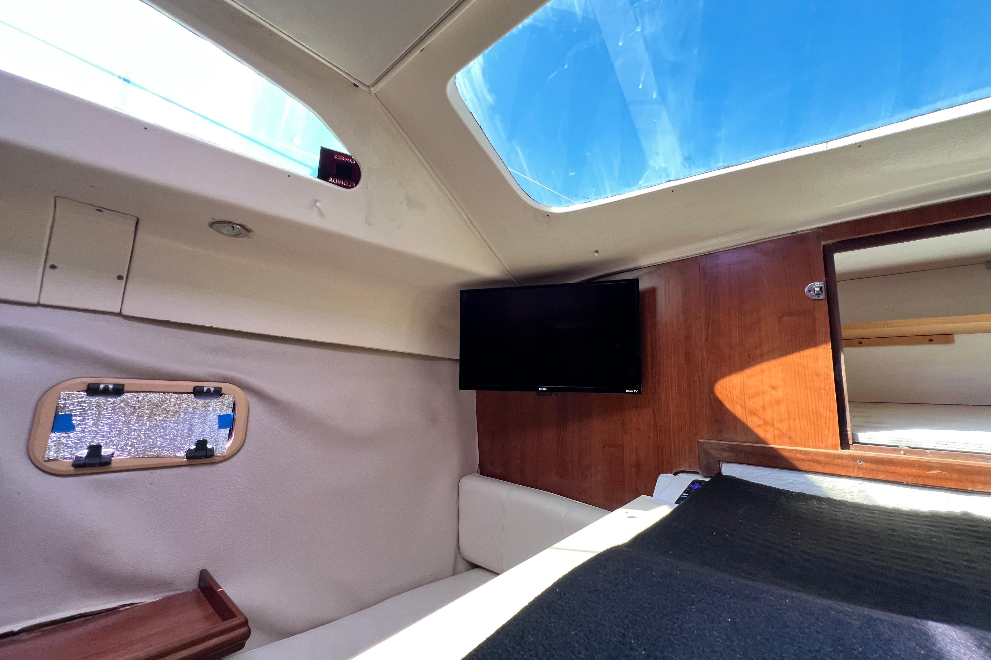 Interior of 2013 Gemini Legacy 35 sailboat with skylight and mounted TV.