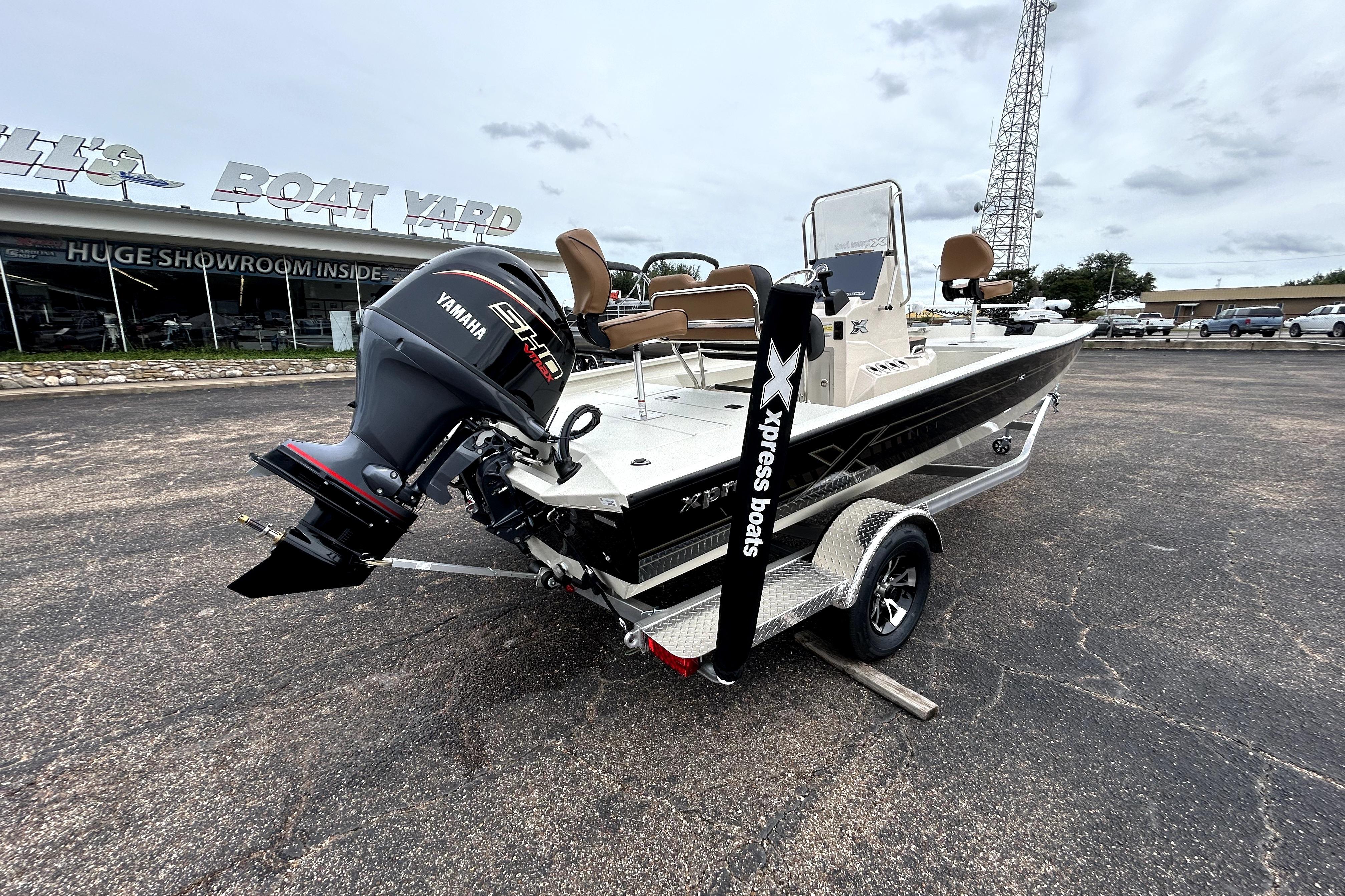 2026 Xpress H20B Bay boat with Yamaha engine on trailer at dealership.