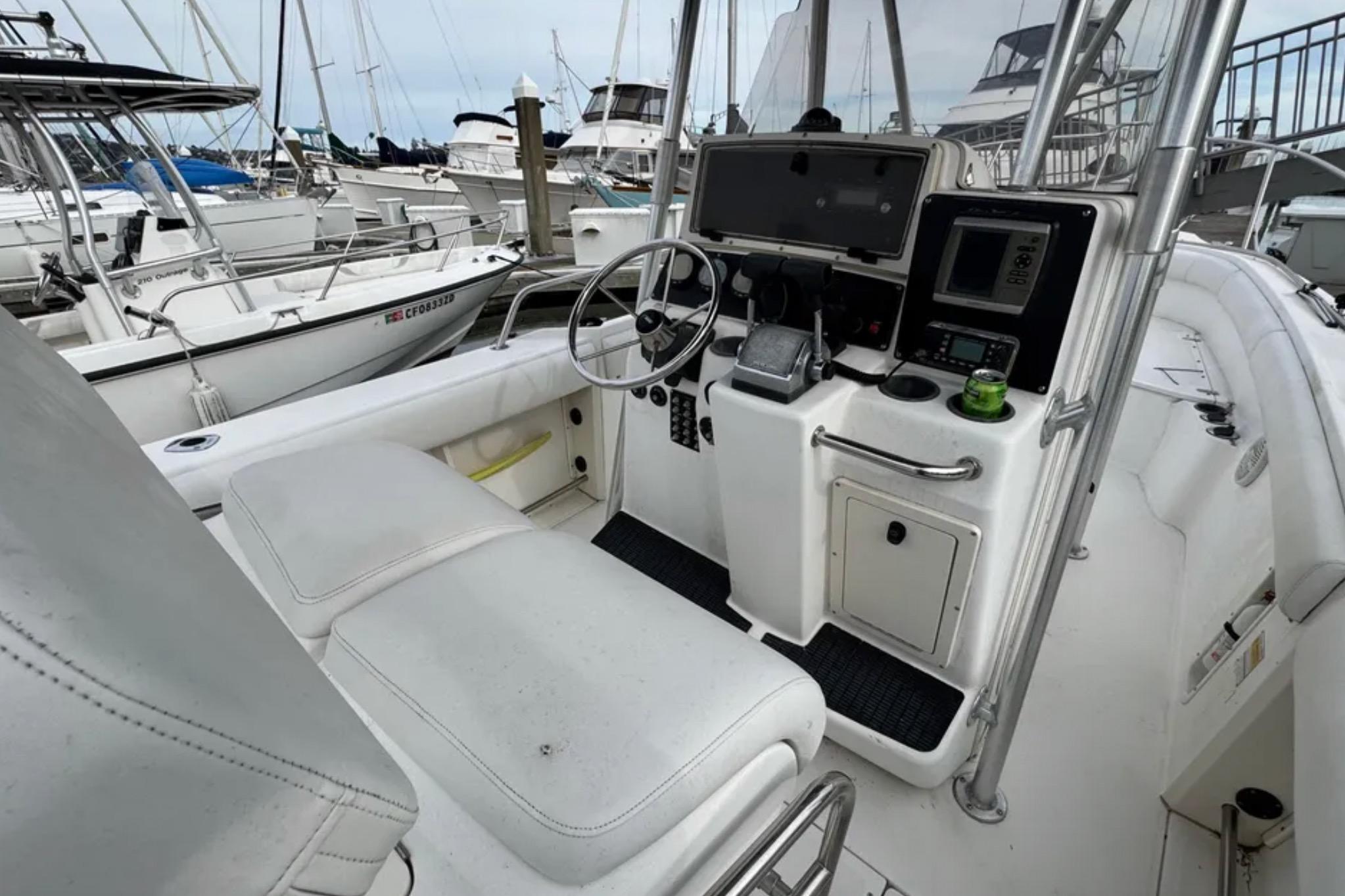 2001 Boston Whaler 26 Outrage boat interior with steering console and navigation equipment.