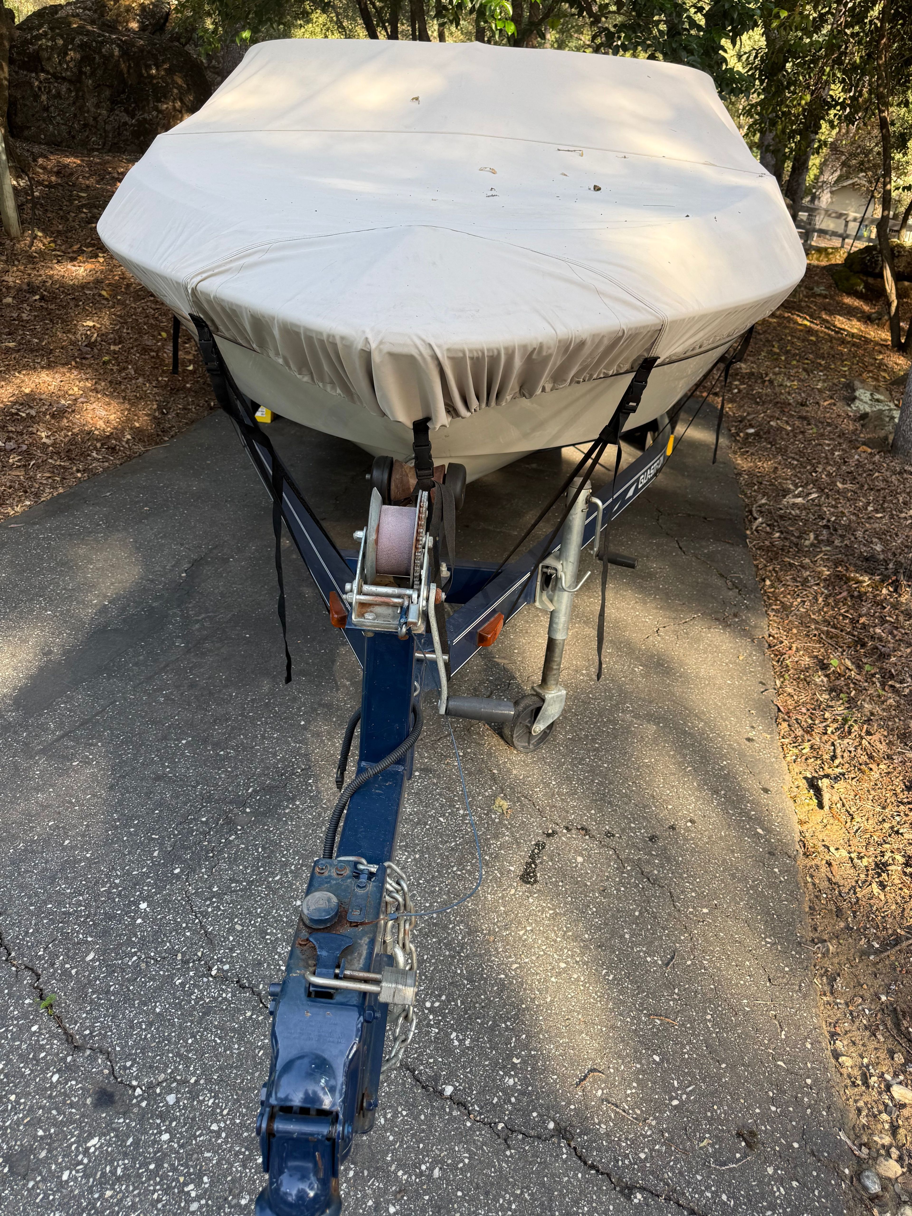 Covered 2003 Glastron SX 195 boat on trailer.