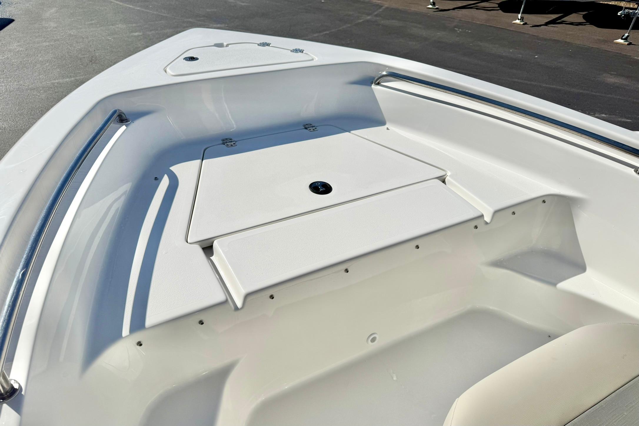 2026 Key West 189 FS boat deck with storage compartment and stainless steel railing.