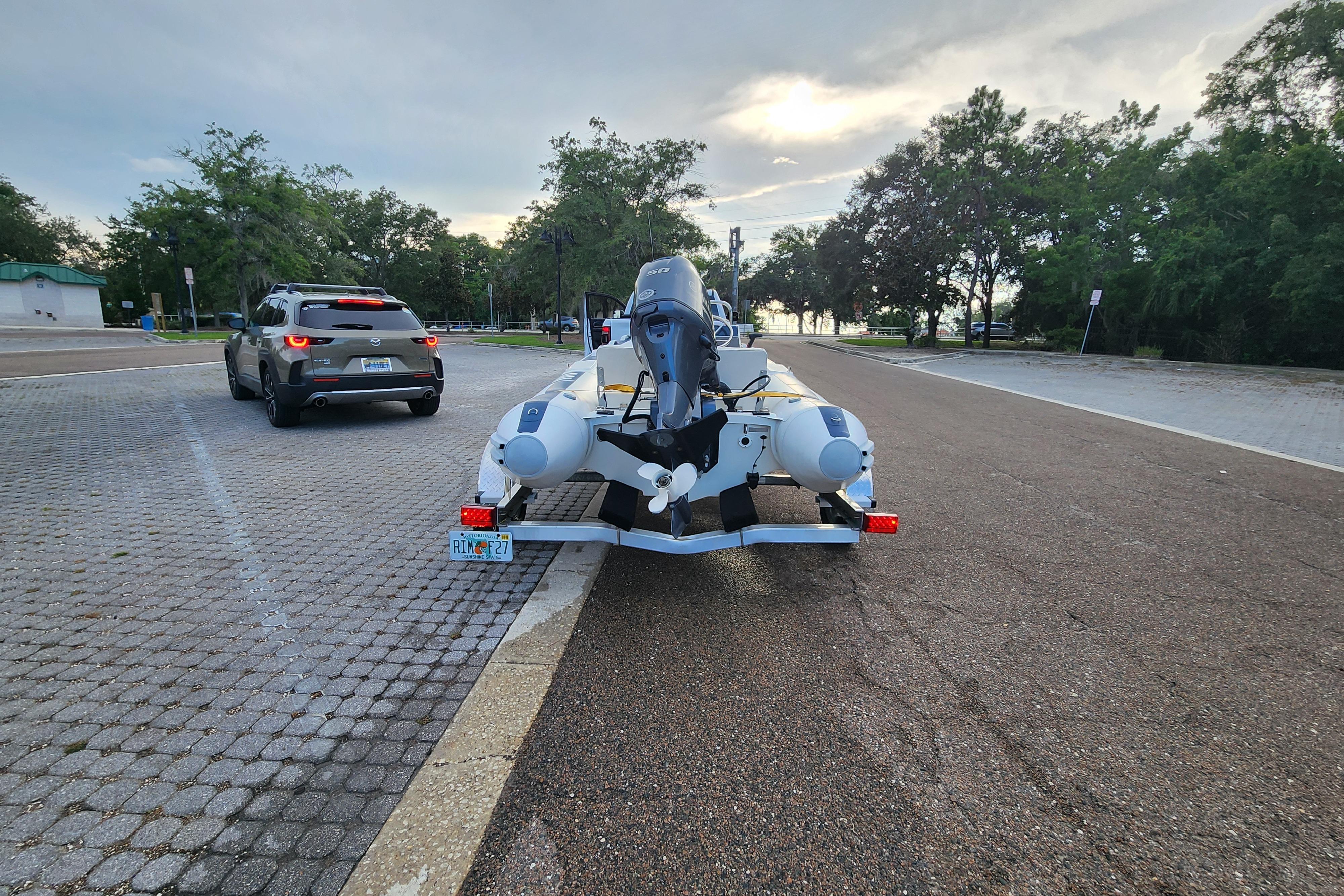 2019 Novurania DL 400 boat on trailer in parking lot, overcast sky.