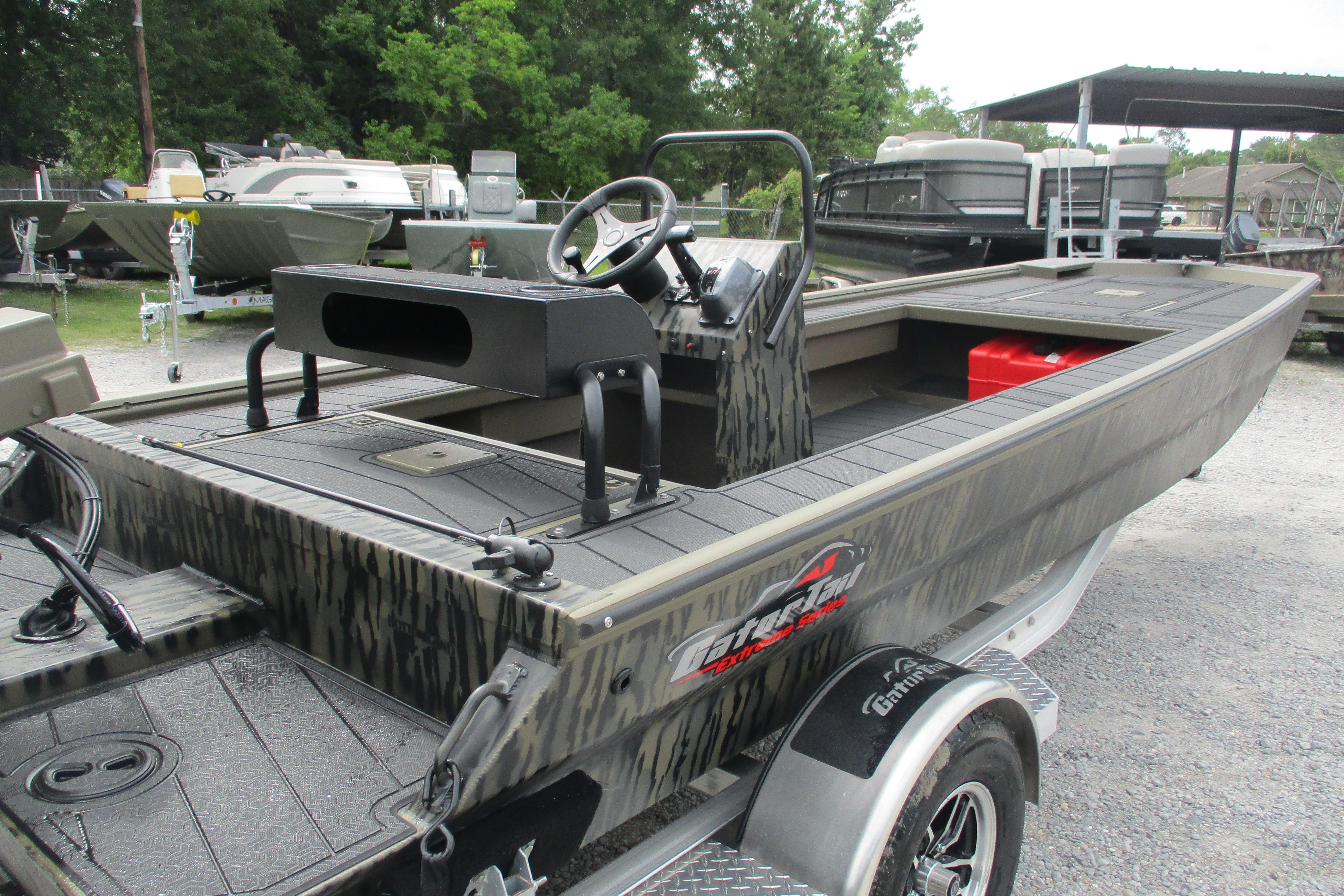 2026 Gator Tail 2060 Extreme CC boat on trailer, featuring camouflage design and steering console.