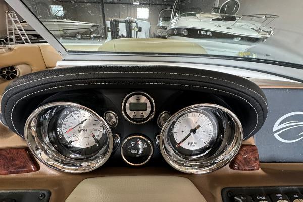 Dashboard of 2023 Crownline 215 XS boat with speedometer and RPM gauges.