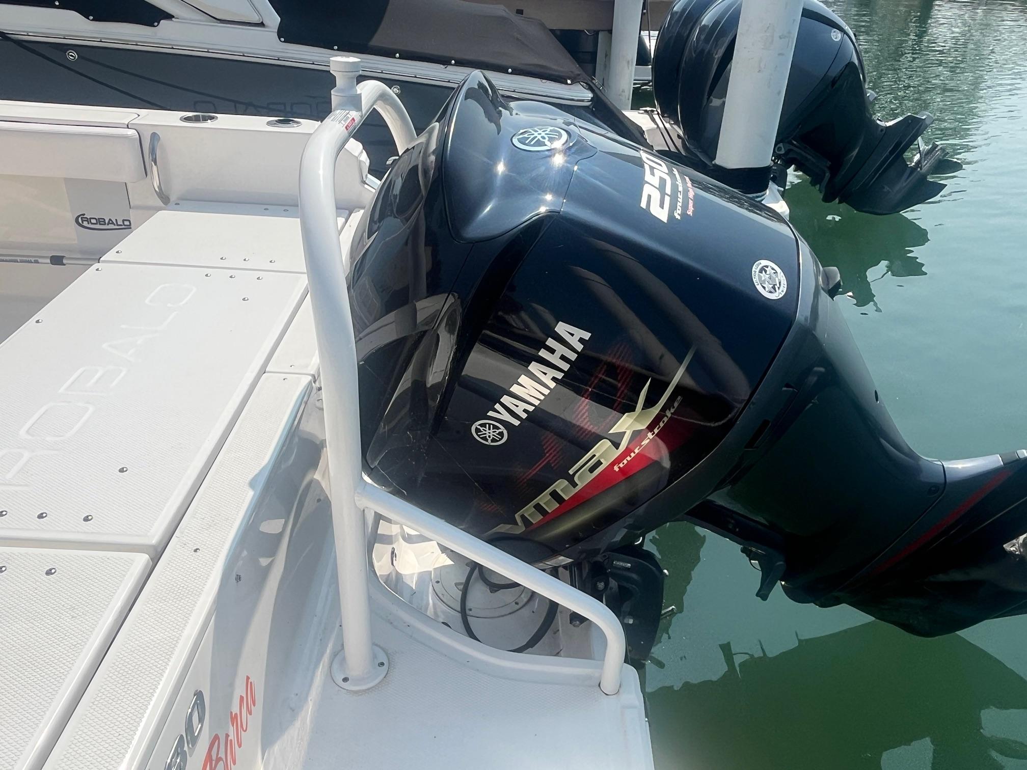 2020 Robalo R230 Center Console with Yamaha outboard engine, docked on calm water.