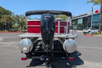 2026 Sun Tracker Party Barge 20 DLX pontoon boat, rear view in parking lot.