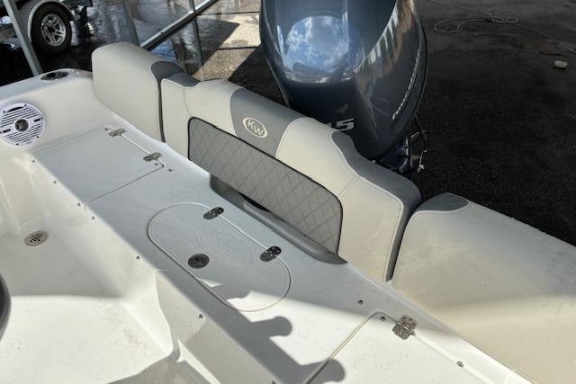 2026 Key West 189 FS boat interior with cushioned seating and outboard motor.