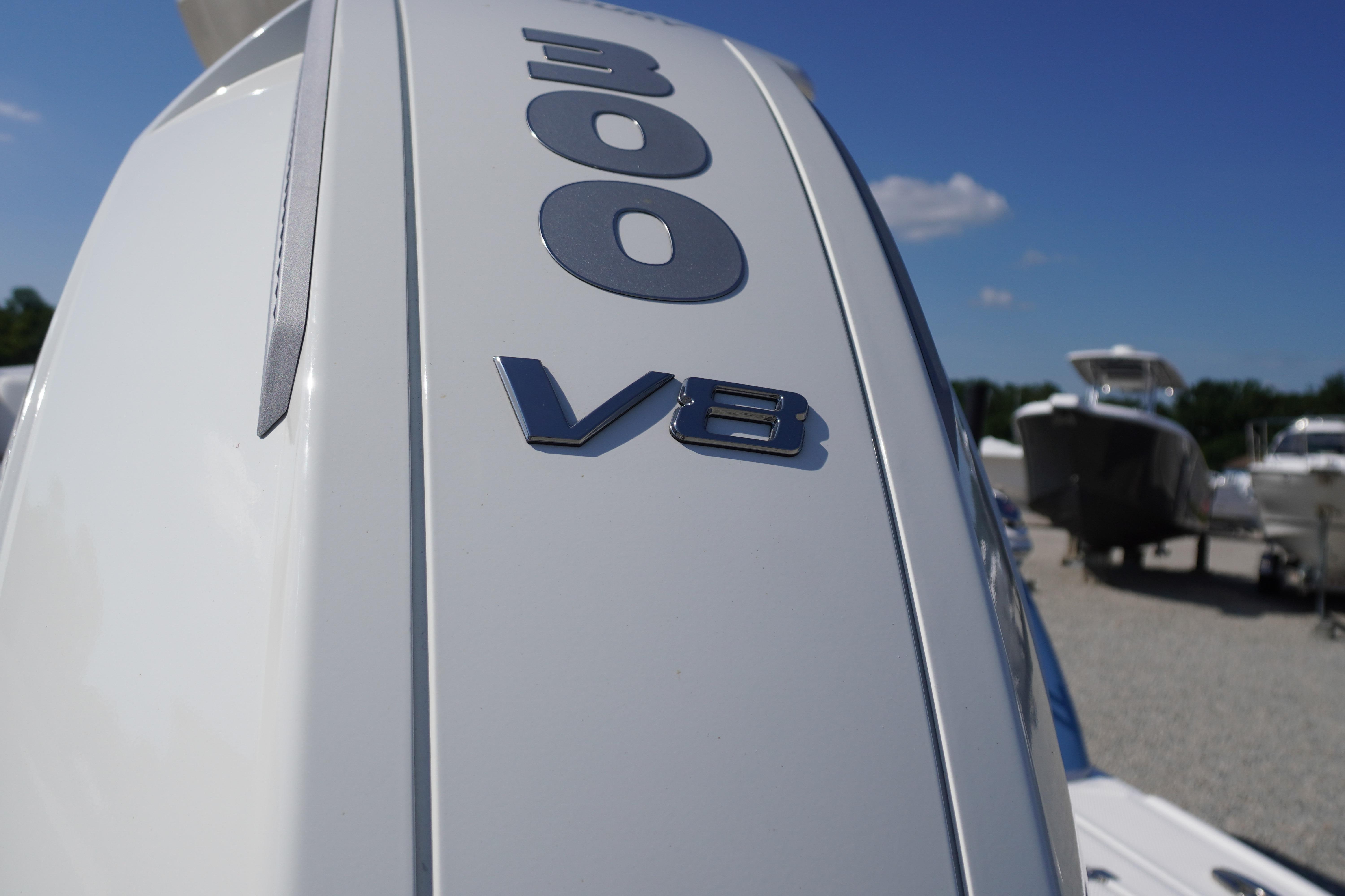 Chaparral 270 OSX 2026 boat engine with 300 V8 emblem under clear blue sky.